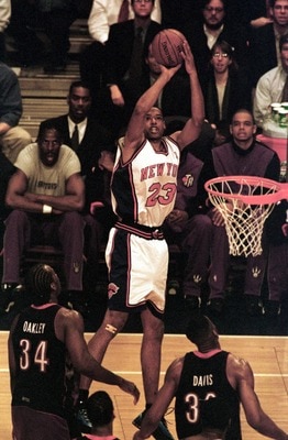 26 Apr 2000:  Marcus Camby #23 of the New York Knicks puts up a shot over Charles Oakley #34 and Antonio Davis #33 of the Toronto Raptors during Game 2 of the first round of the Eastern Conference quarter-finals at Madison Square Garden in New York. Manda