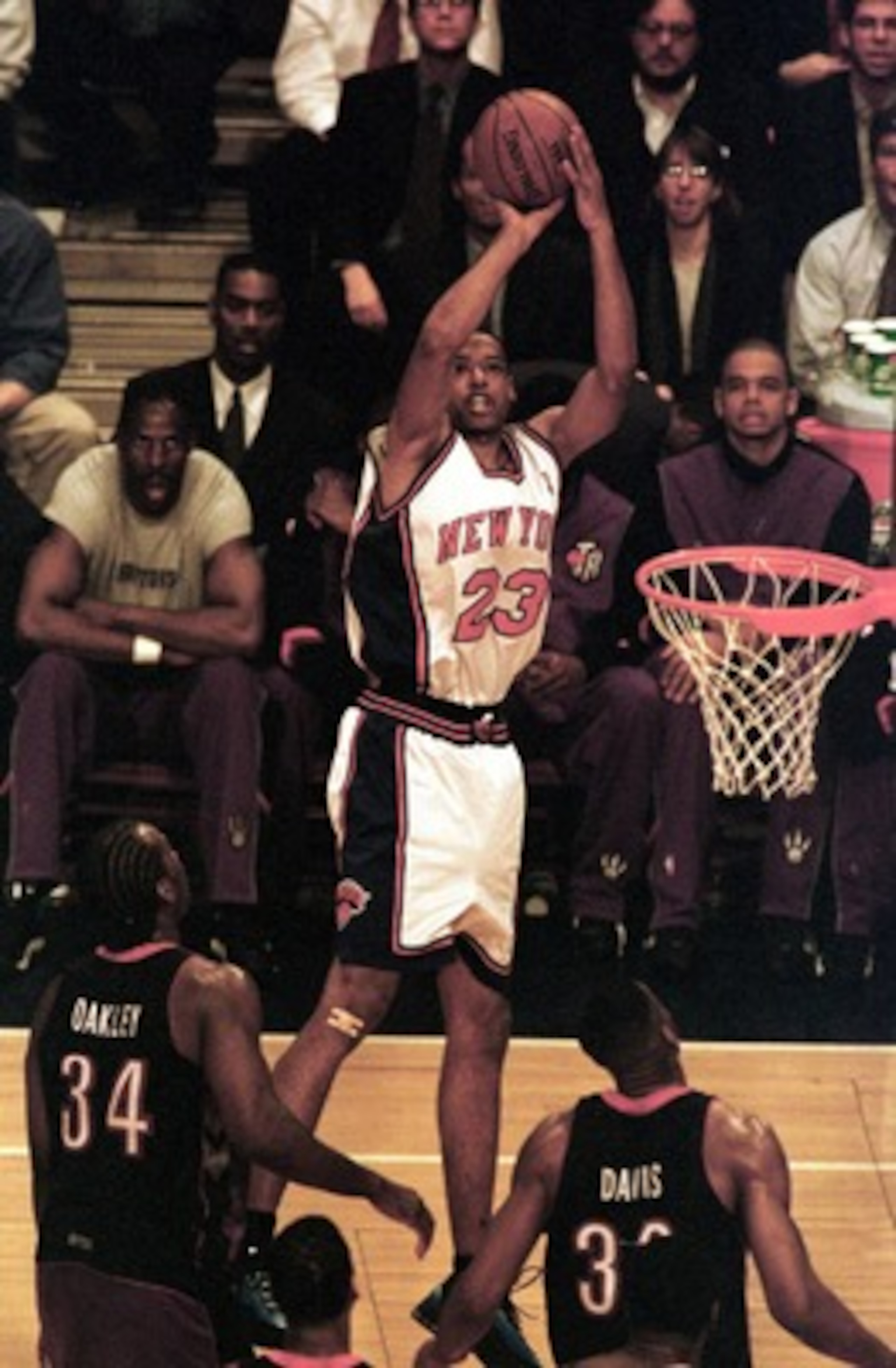 26 Apr 2000:  Marcus Camby #23 of the New York Knicks puts up a shot over Charles Oakley #34 and Antonio Davis #33 of the Toronto Raptors during Game 2 of the first round of the Eastern Conference quarter-finals at Madison Square Garden in New York. Manda