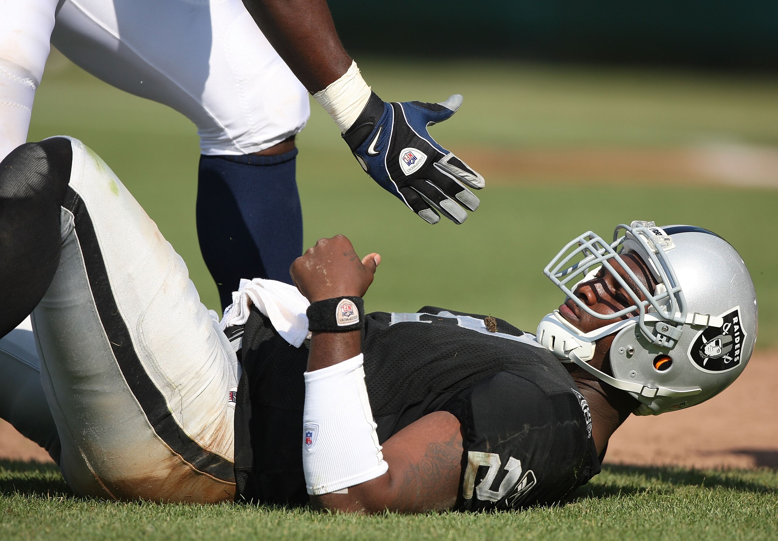 OAKLAND, CA - SEPTEMBER 27:  JaMarcus Russell #2 of the Oakland Raiders is helped up after getting hit against the Denver Broncos on September 27, 2009 during an NFL game at the Oakland-Alameda County Coliseum in Oakland, California.  (Photo by Jed Jacobs