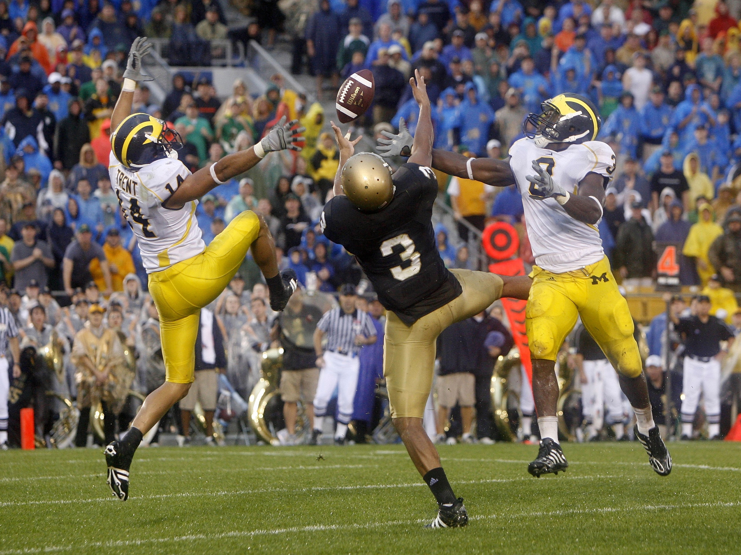SOUTH BEND, IN - SEPTEMBER 13:  Michael Floyd #3 of the Notre Dame Fighting Irish can't hold onto a pass between Morgan Trent #14 and Stevie Brown #3 of the Michigan Wolverines on September 13, 2008 at Notre Dame Stadium in South Bend, Indiana. Notre Dame
