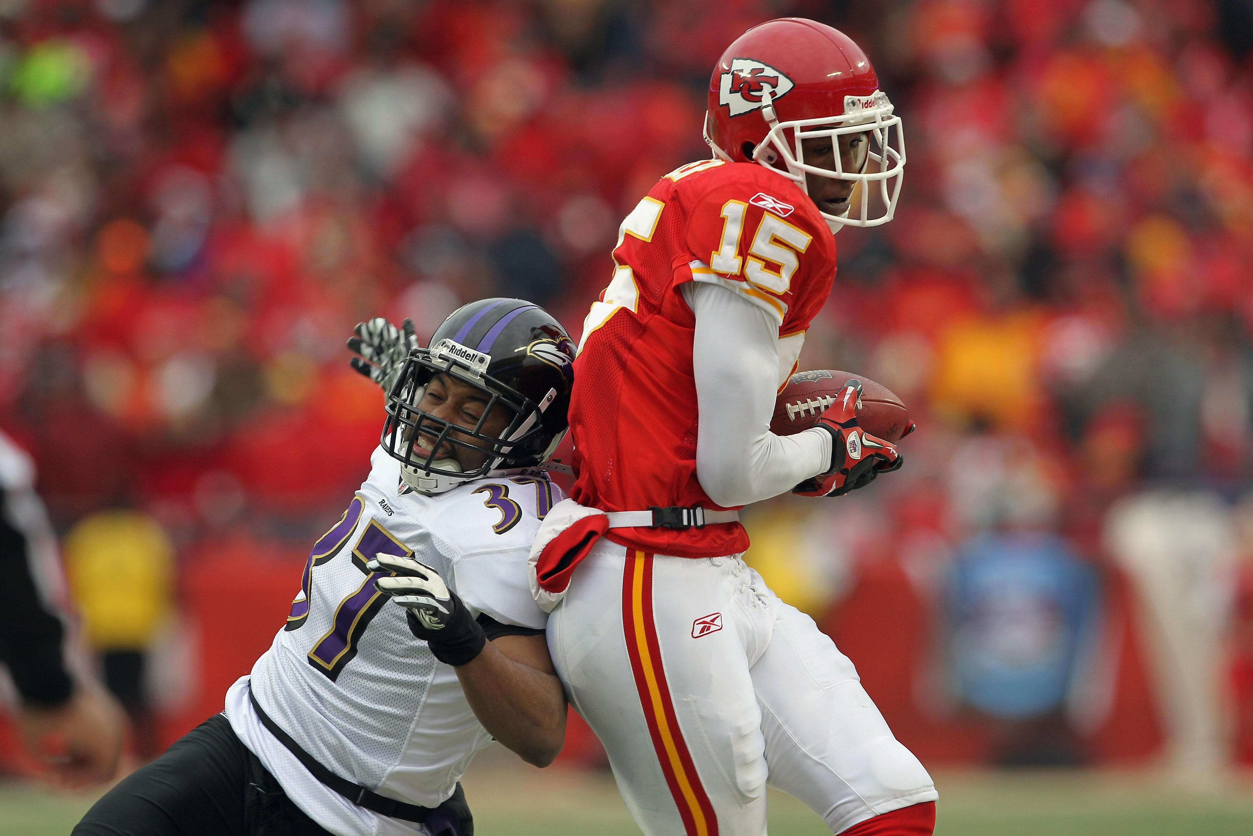 KANSAS CITY, MO - JANUARY 09:  Wide receiver Verran Tucker #15 of the Kansas City Chiefs makes a reception out of bounds as corner back Josh Wilson #37 of the Baltimore Ravens defends as the Ravens defeated the Chiefs 30-7 in their 2011 AFC wild card play