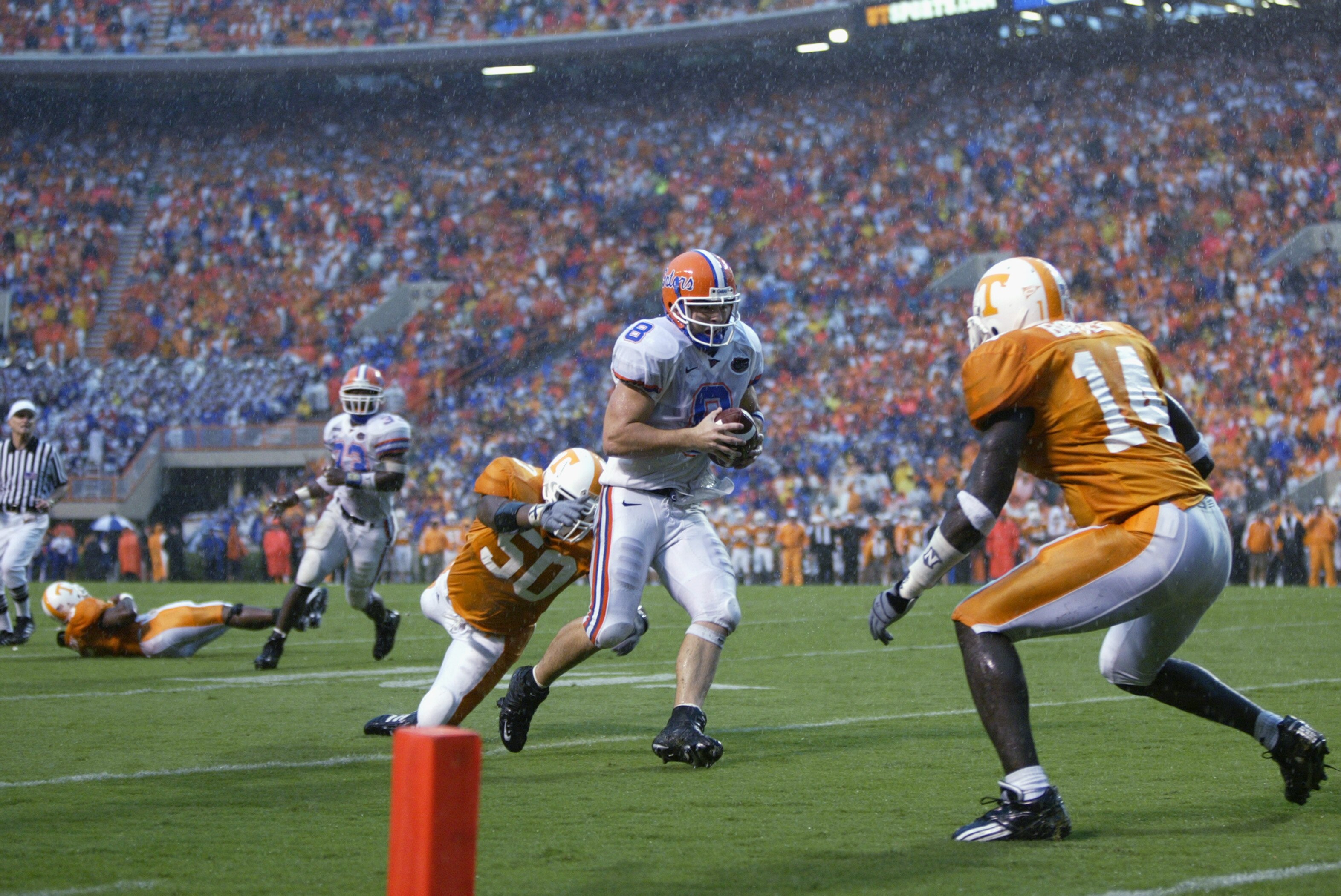 KNOXVILLE, TN - SEPTEMBER 21:  Quarterback Rex Grossman #8 of the Florida Gators is chased by Deyon Whiteside #50 and Julian Battle #14 of the Tennessee Volunteers on September 21, 2002 at Neyland Stadium in Knoxville, Tennessee.  Florida defeated Tenness