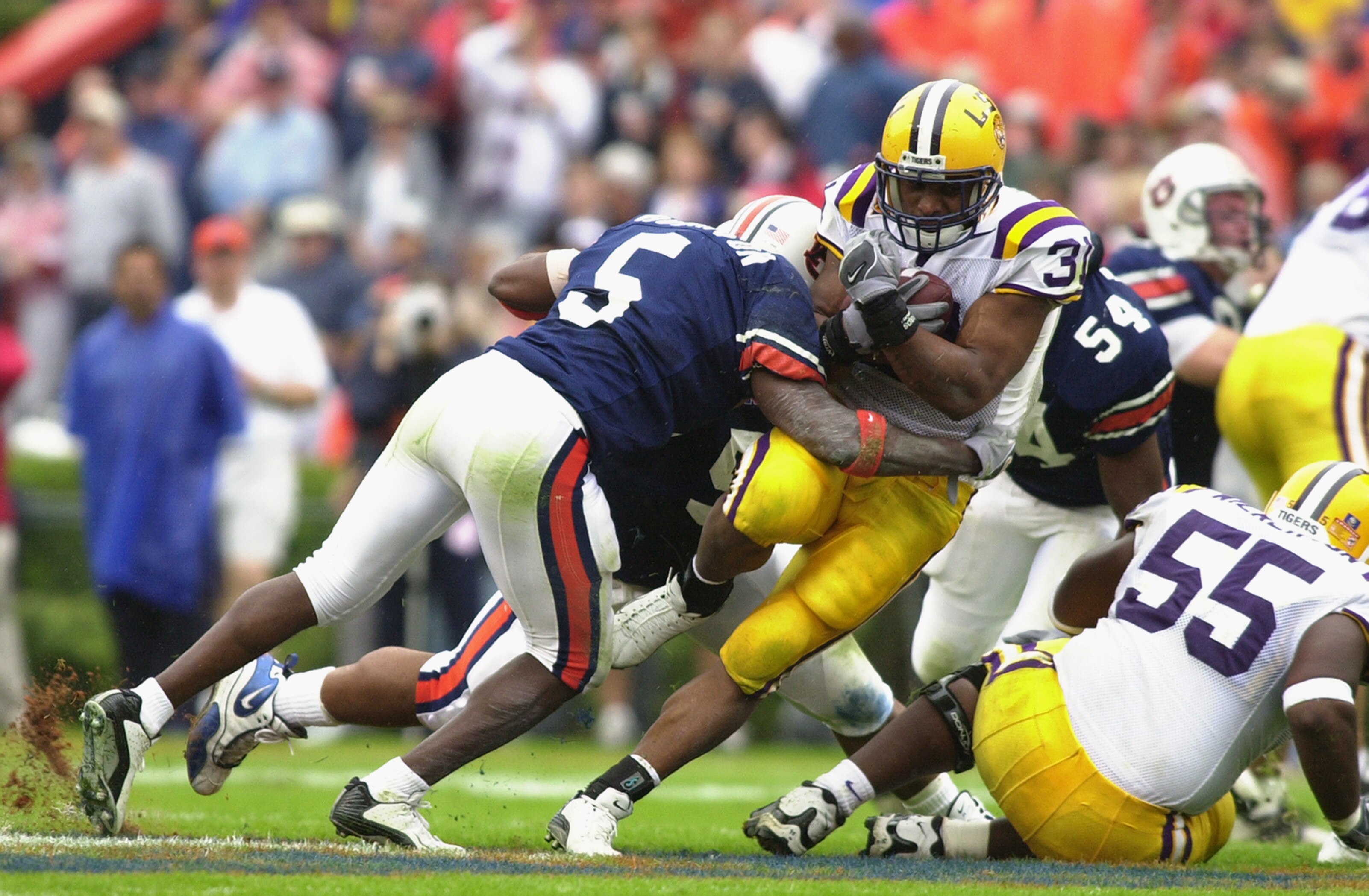 AUBURN, AL - OCTOBER 26:  Running back Domanick Davis #31 of LSU is taken down by safety Travaris Robinson #5 of Auburn during the first half of the SEC matchup on October 26, 2002 at Jordan-Hare Stadium in Auburn, Alabama.  Auburn defeated LSU 31-7.  (Ph