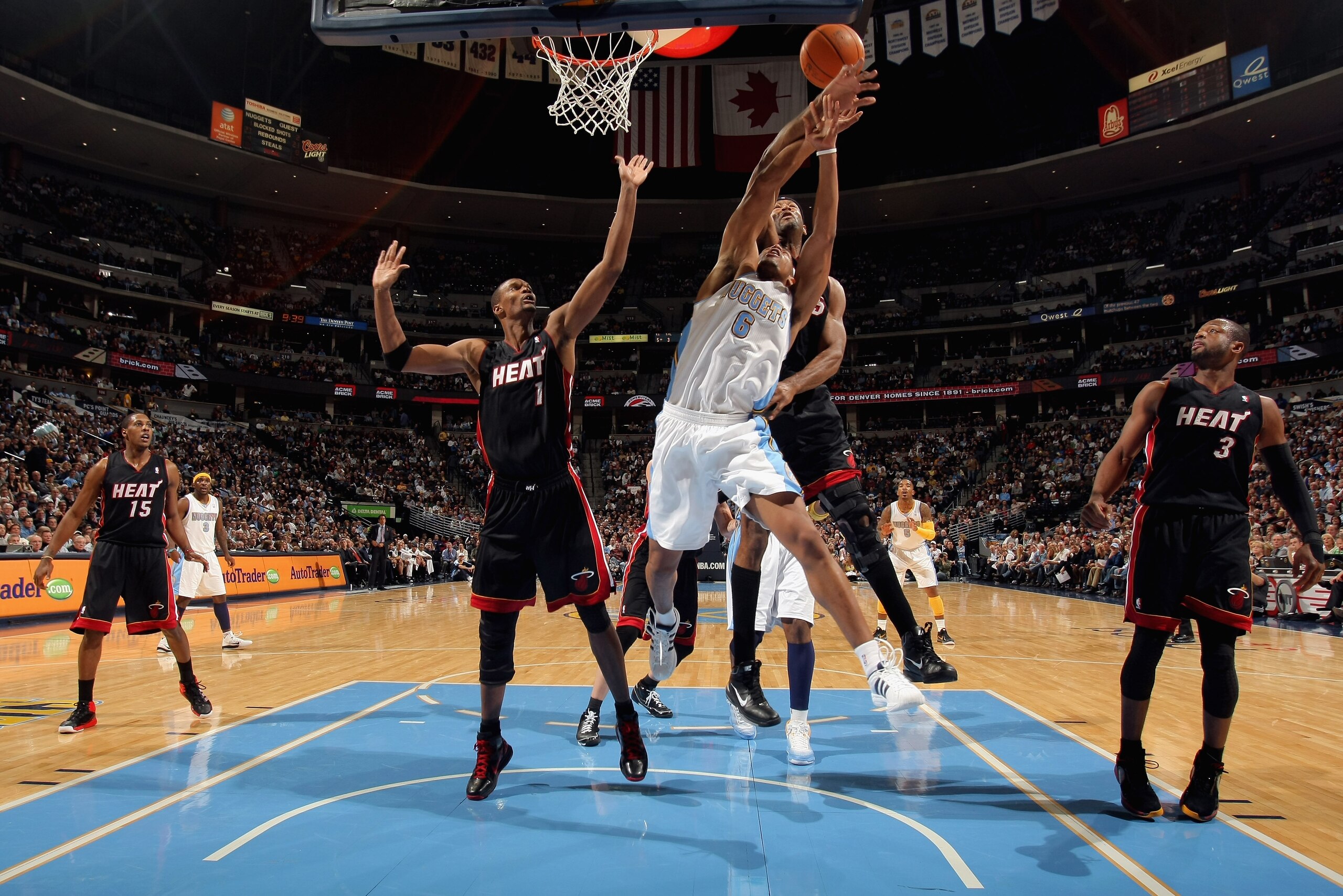 DENVER, CO - JANUARY 13: Arron Afflalo #6 of the Denver Nuggets battles for a rebound wtih Erick Dampier #25 of the Miami Heat as Chris Bosh #1 and Dwayne Wade #3 of the Heat follow the action at the Pepsi Center on January 13, 2011 in Denver, Colorado. DENVER, CO - JANUARY 13: Arron Afflalo #6 of the Denver Nuggets battles for a rebound wtih Erick Dampier #25 of the Miami Heat as Chris Bosh #1 and Dwayne Wade #3 of the Heat follow the action at the Pepsi Center on January 13, 2011 in Denver, Colorado.