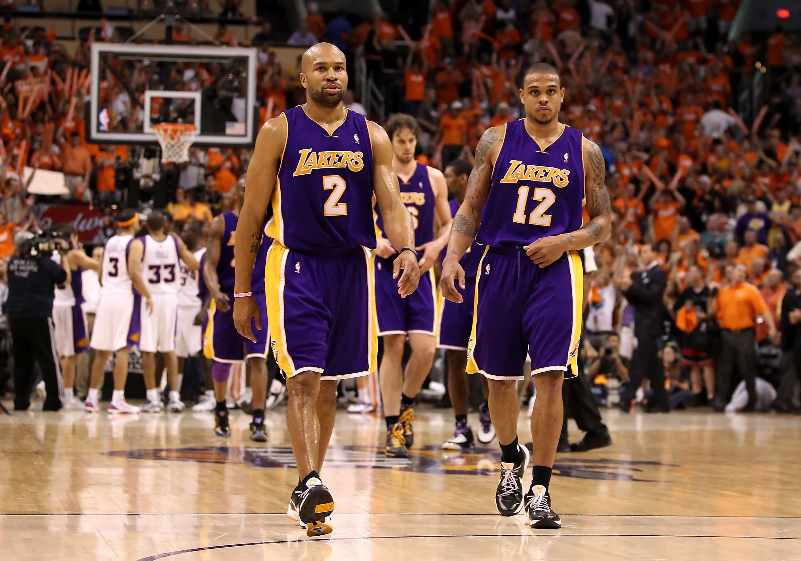 PHOENIX - MAY 23:  Derek Fisher #2 and Shannon Brown #12 of the Los Angeles Lakers walk off the court after being defeated by the Phoenix Suns in Game Three of the Western Conference finals of the 2010 NBA Playoffs at US Airways Center on May 23, 2010 in