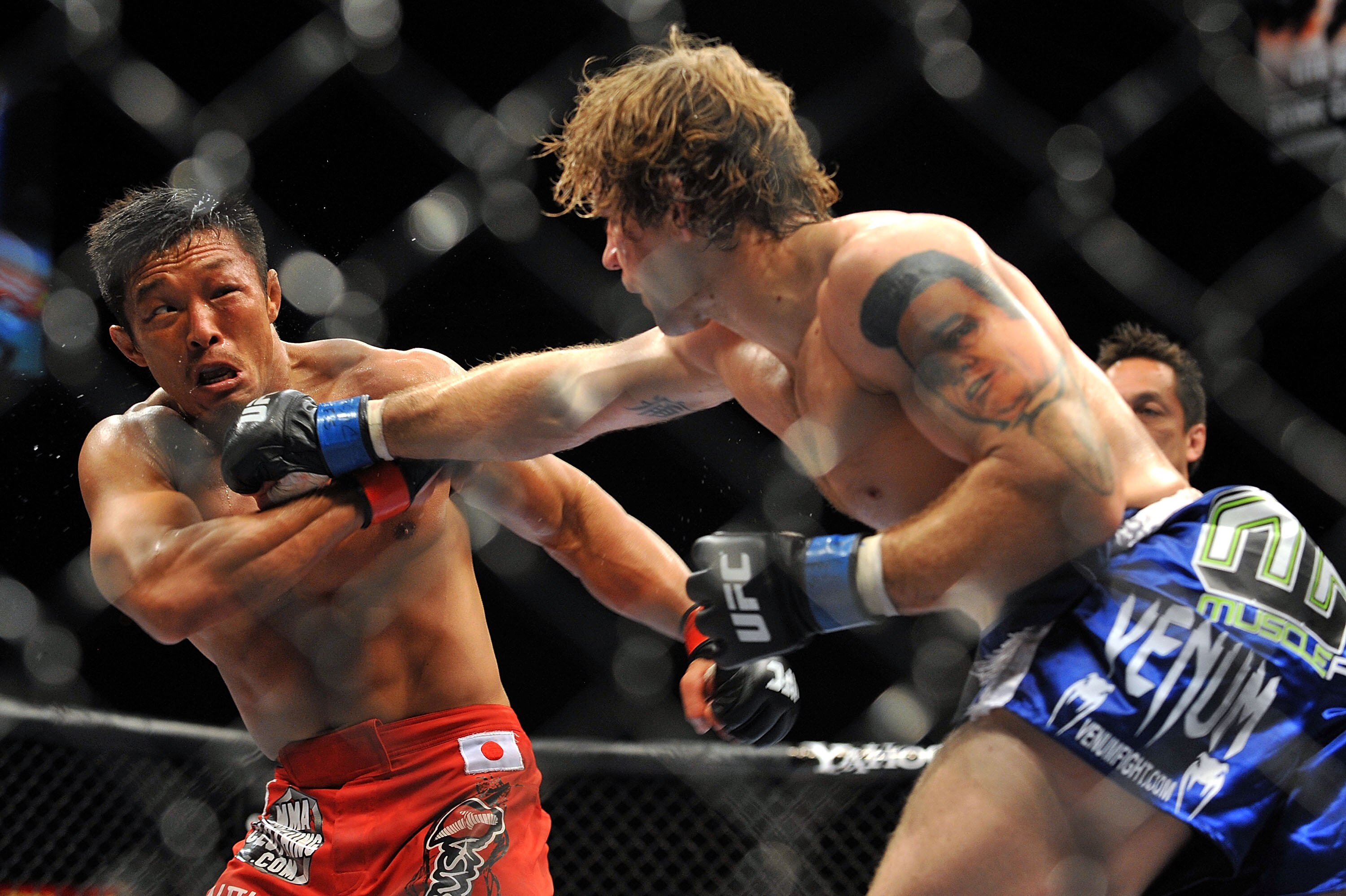 LAS VEGAS - JULY 11:  (R-L) Alan Belcher throws a right at Yoshihiro Akiyama during their middleweight bout during UFC 100 on July 11, 2009 in Las Vegas, Nevada.  (Photo by Jon Kopaloff/Getty Images)