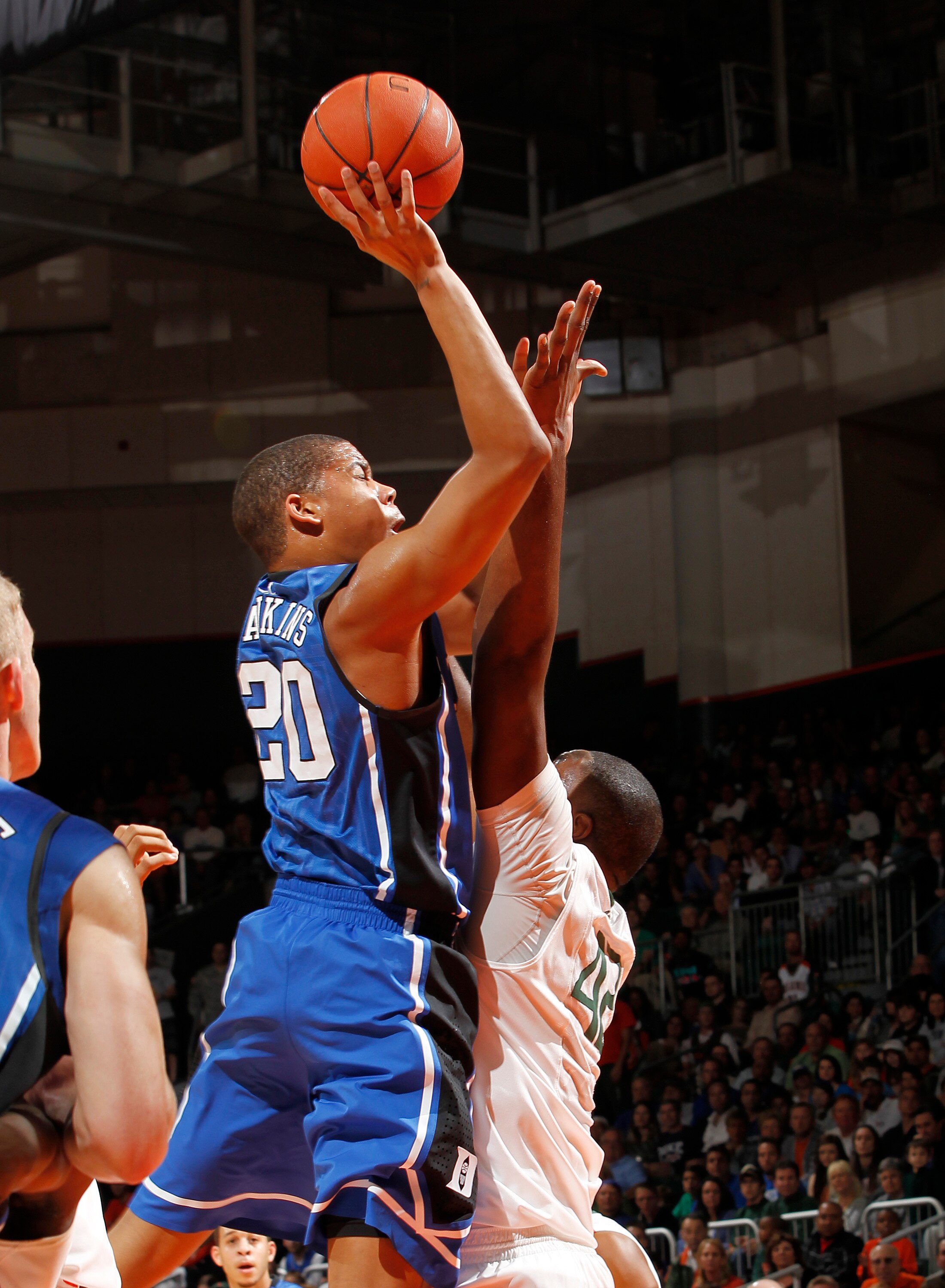CORAL GABLES, FL - FEBRUARY 13: Andre Dawkins #20 of the Duke Blue Devils shoots the ball over Reggie Johnson #42 of the Miami Hurricanes on February 13, 2011 at the BankUnited Center in Coral Gables, Florida. (Photo by Joel Auerbach/Getty Images)