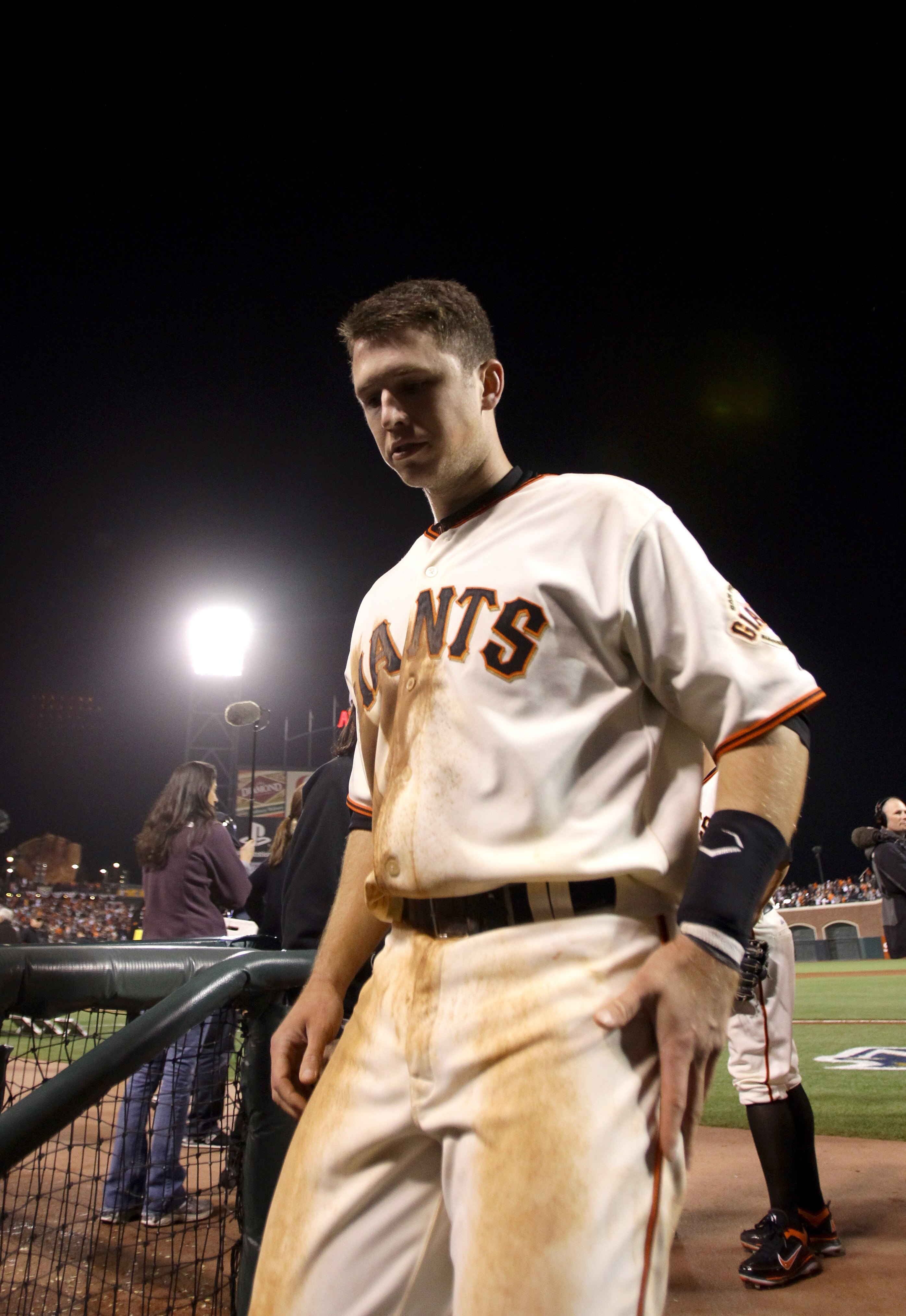 SAN FRANCISCO - OCTOBER 07:  Buster Posey #28 of the San Francisco Giants walks of the field after they beat the Atlanta Braves in game 1 of the NLDS at AT&T Park on October 7, 2010 in San Francisco, California.  (Photo by Ezra Shaw/Getty Images)