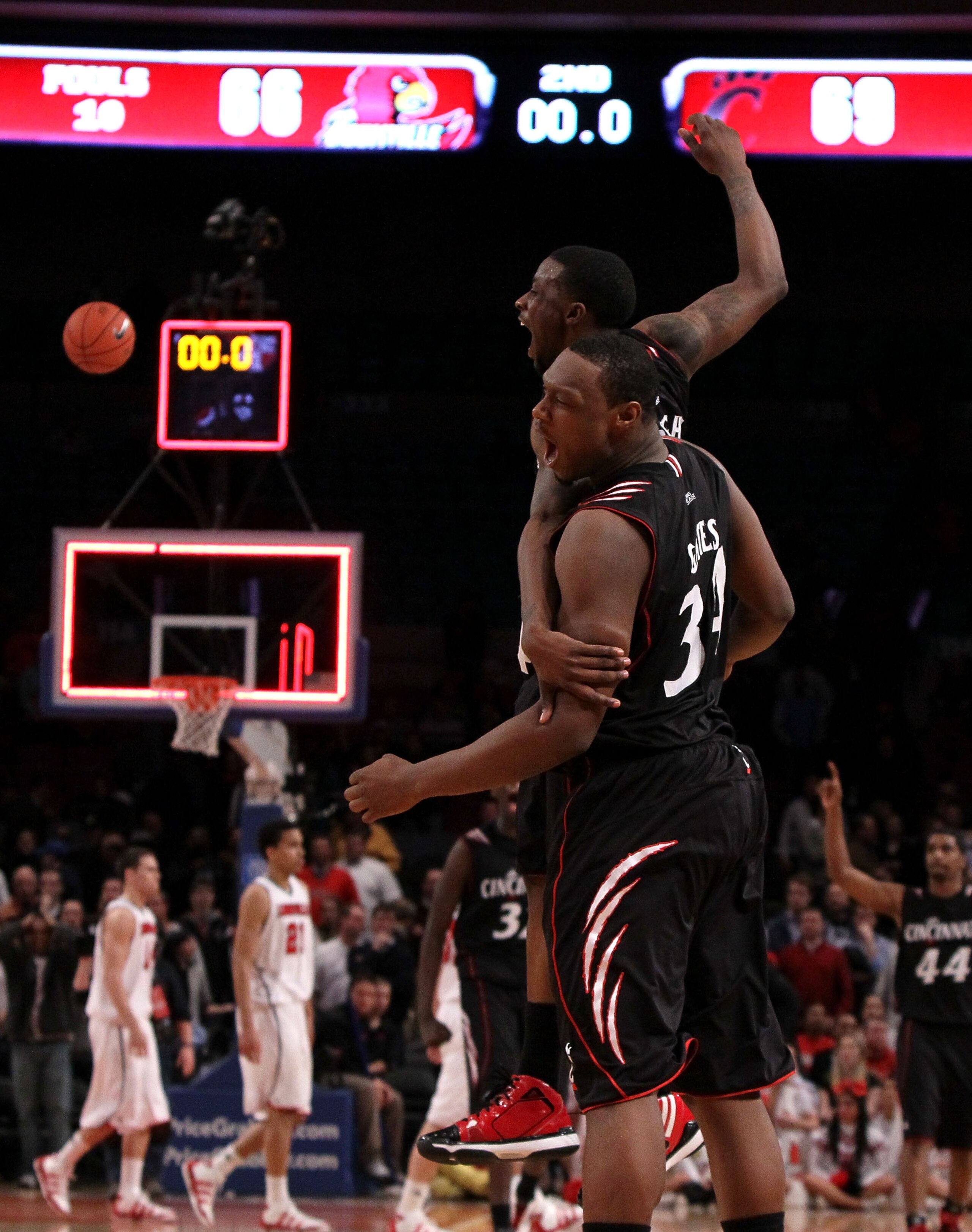 NEW YORK - MARCH 10:  Cashmere Wright #1 and Yancy Gates #34 of the Cincinnati Bearcats celebrate after defeating the Louisville Cardinals during the second round of 2010 NCAA Big East Tournament at Madison Square Garden on March 10, 2010 in New York City