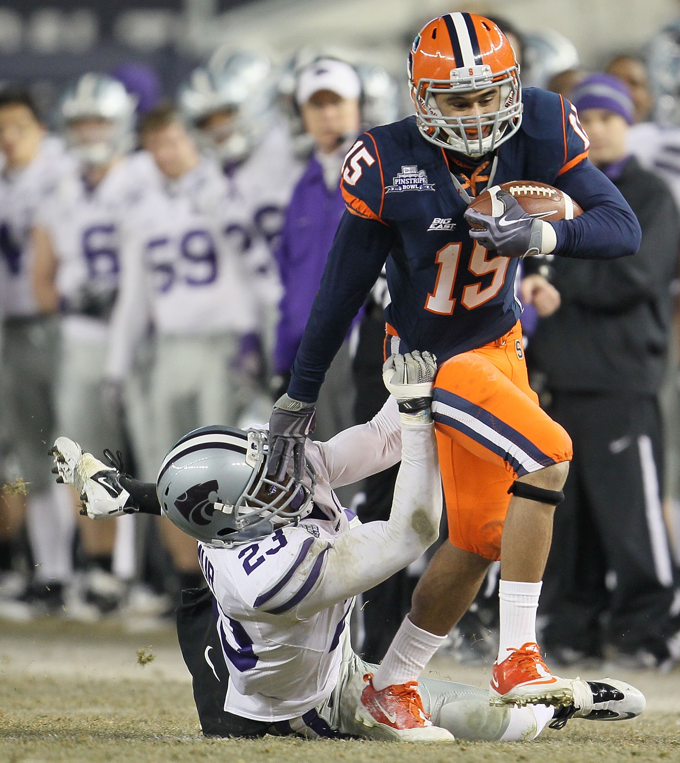 NEW YORK, NY - DECEMBER 30: Alec Lemon #15 of the Syracuse Orange is tackled by Emmanuel Lamur #23 of the Kansas State Wildcats during the New Era Pinstripe Bowl at Yankee Stadium on December 30, 2010 in New York, New York. (Photo by Chris McGrath/Getty NEW YORK, NY - DECEMBER 30: Alec Lemon #15 of the Syracuse Orange is tackled by Emmanuel Lamur #23 of the Kansas State Wildcats during the New Era Pinstripe Bowl at Yankee Stadium on December 30, 2010 in New York, New York. (Photo by Chris McGrath/Getty