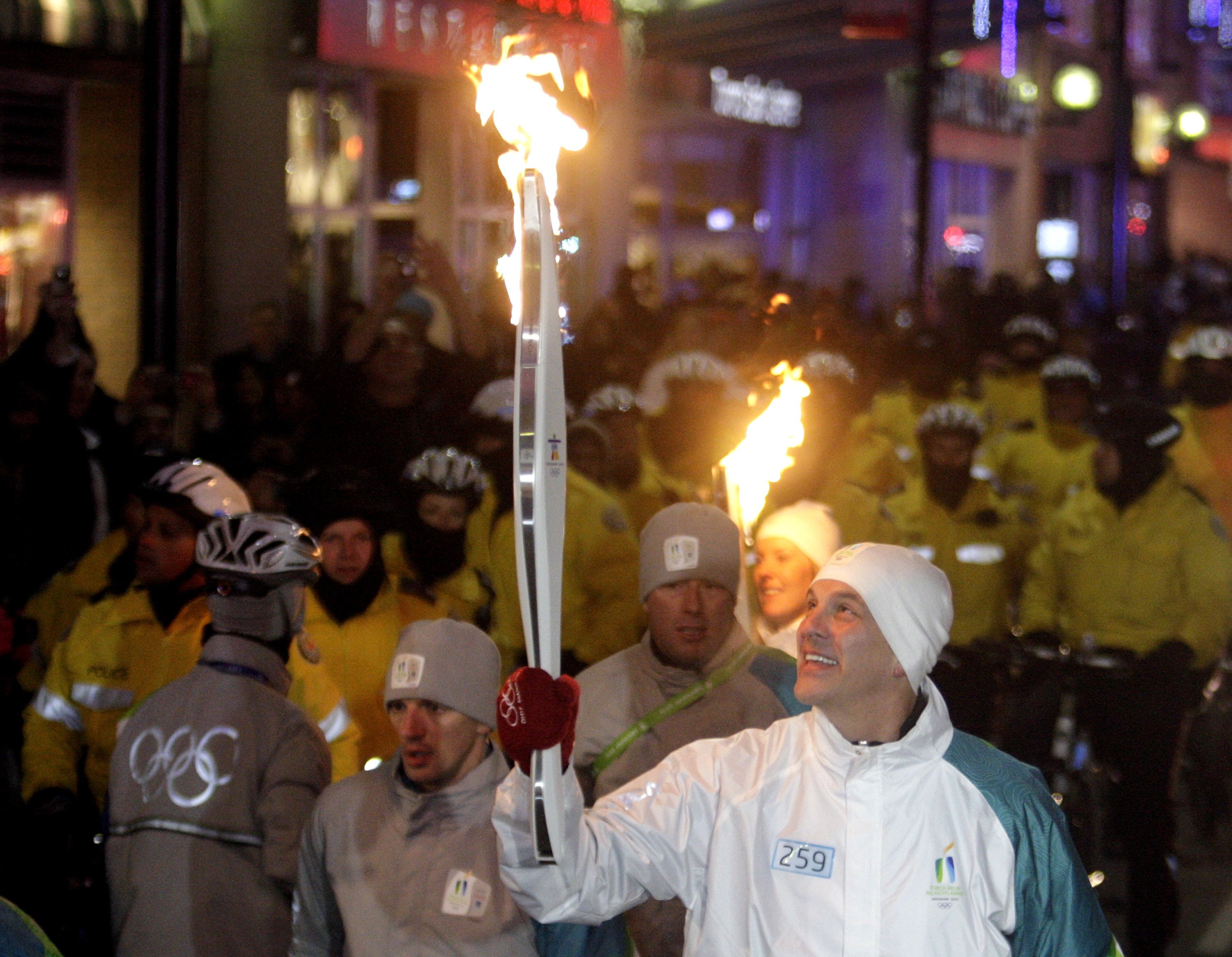 TORONTO - DECEMBER 17:   Raptors Head Coach Jay Triano carries the torch down Yonge Street during the Vancouver 2010 Olympic Torch Relay on December 17, 2009 in Toronto, Ontario, Canada. (Photo by Abelimages/Getty Images)