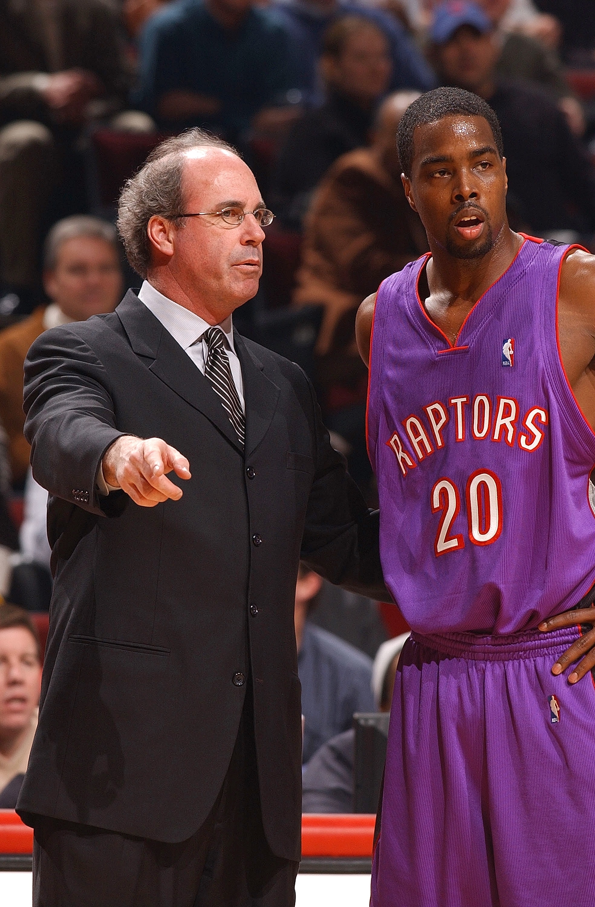 CHICAGO - FEBRUARY 17:  Head coach Kevin O'Neill of the Toronto Raptors gives instructions to guard Alvin Williams #20 during a game against the Chicago Bulls on February 17, 2004 at the United Center in Chicago, Illinois. The Bulls defeated the Raptors 7