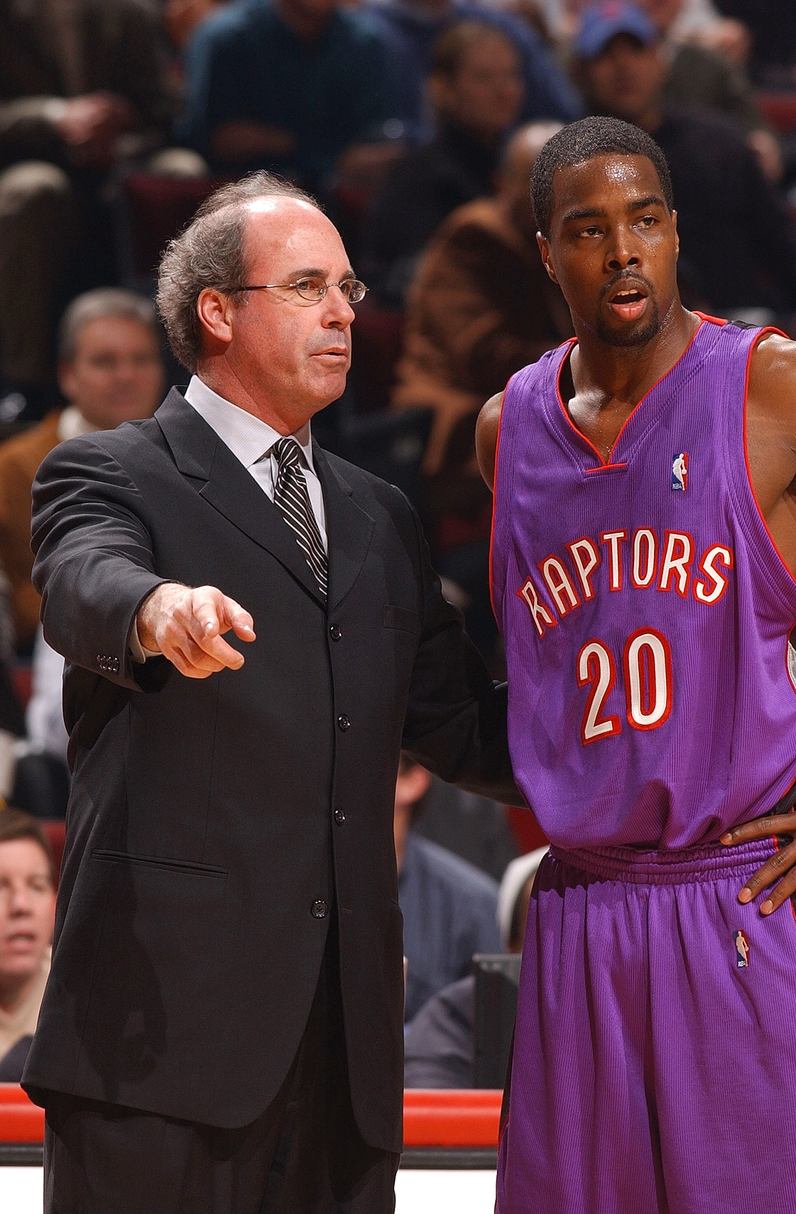 CHICAGO - FEBRUARY 17:  Head coach Kevin O'Neill of the Toronto Raptors gives instructions to guard Alvin Williams #20 during a game against the Chicago Bulls on February 17, 2004 at the United Center in Chicago, Illinois. The Bulls defeated the Raptors 7