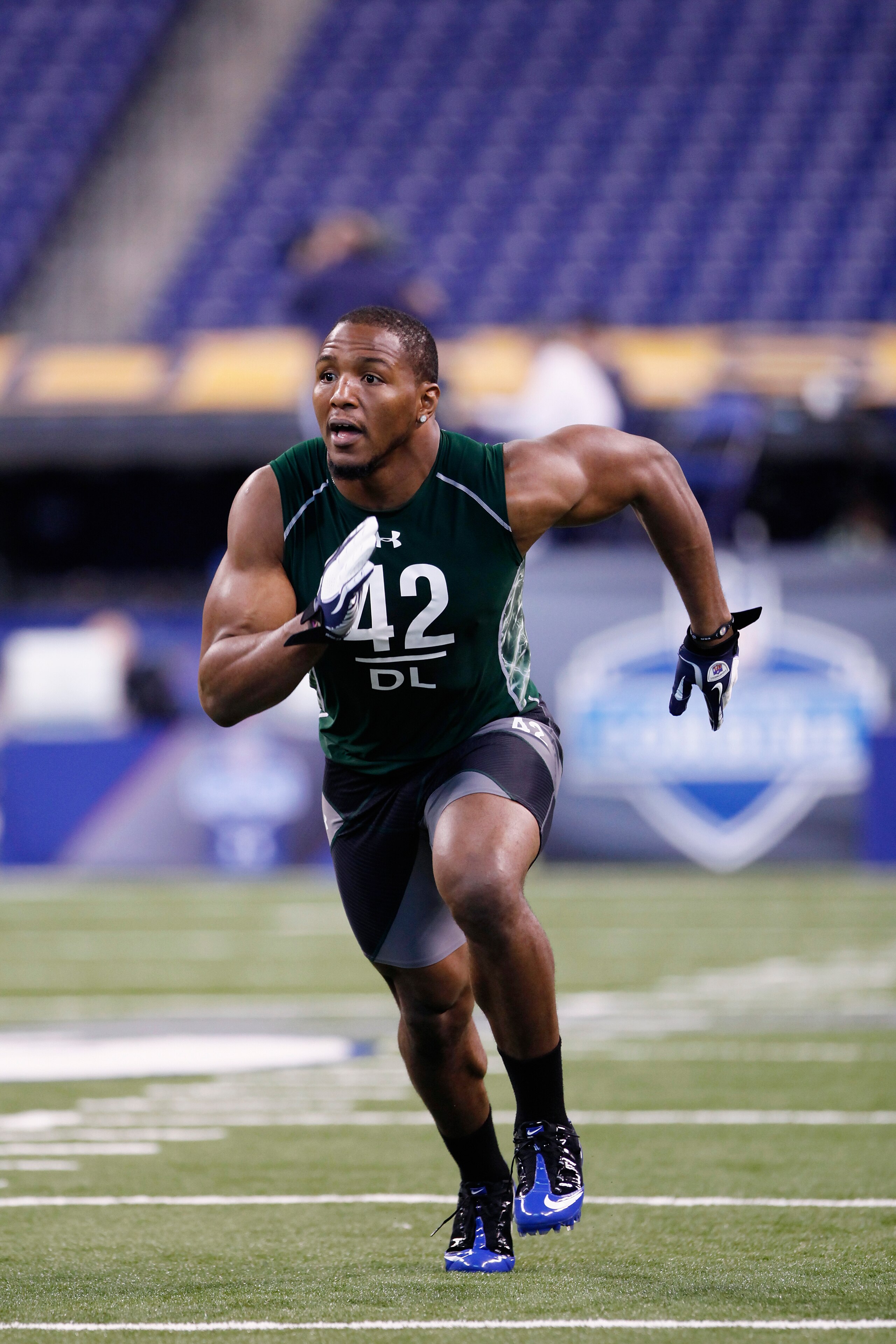 INDIANAPOLIS, IN - FEBRUARY 28:  Defensive lineman Robert Quinn of North Carolina runs through a drill during the 2011 NFL Scouting Combine at Lucas Oil Stadium on February 28, 2011 in Indianapolis, Indiana. (Photo by Joe Robbins/Getty Images)