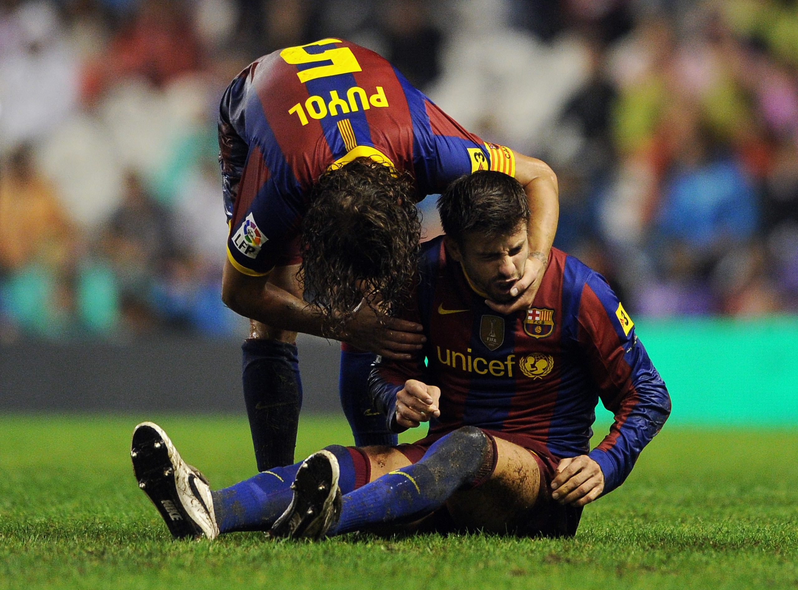 BILBAO, SPAIN - SEPTEMBER 25: Gerard Pique (R) of Barcelona is comforted by his teammate Carles Puyol during the La Liga match between Athletic Bilbao and Barcelona at the San Mames Stadium on September 25, 2010 in Bilbao, Spain. Barcelona won the match BILBAO, SPAIN - SEPTEMBER 25: Gerard Pique (R) of Barcelona is comforted by his teammate Carles Puyol during the La Liga match between Athletic Bilbao and Barcelona at the San Mames Stadium on September 25, 2010 in Bilbao, Spain. Barcelona won the match