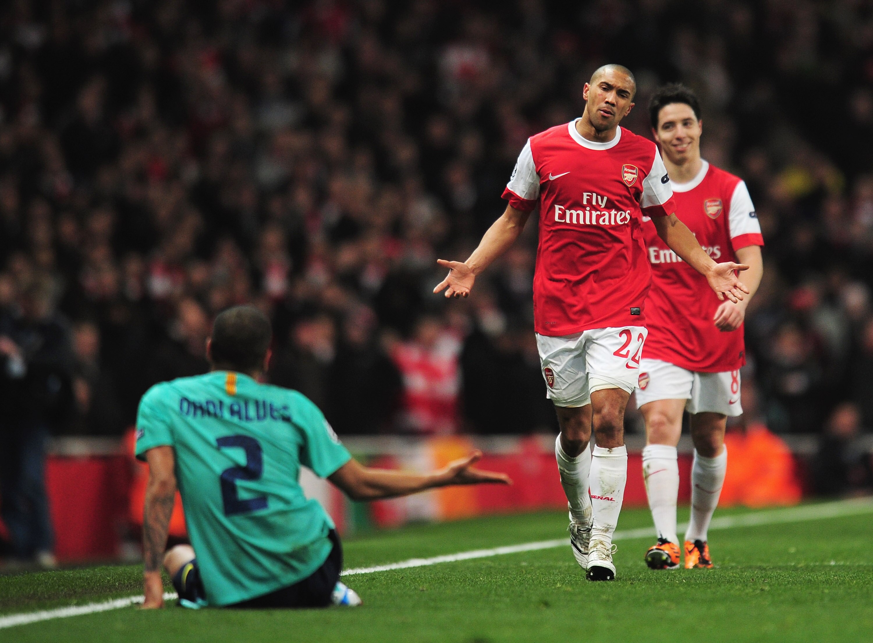 LONDON, ENGLAND - FEBRUARY 16:  Gael Clichy of Arsenal is frustrated by Daniel Alves of Barcelona during the UEFA Champions League round of 16 first leg match between Arsenal and Barcelona at the Emirates Stadium on February 16, 2011 in London, England.  