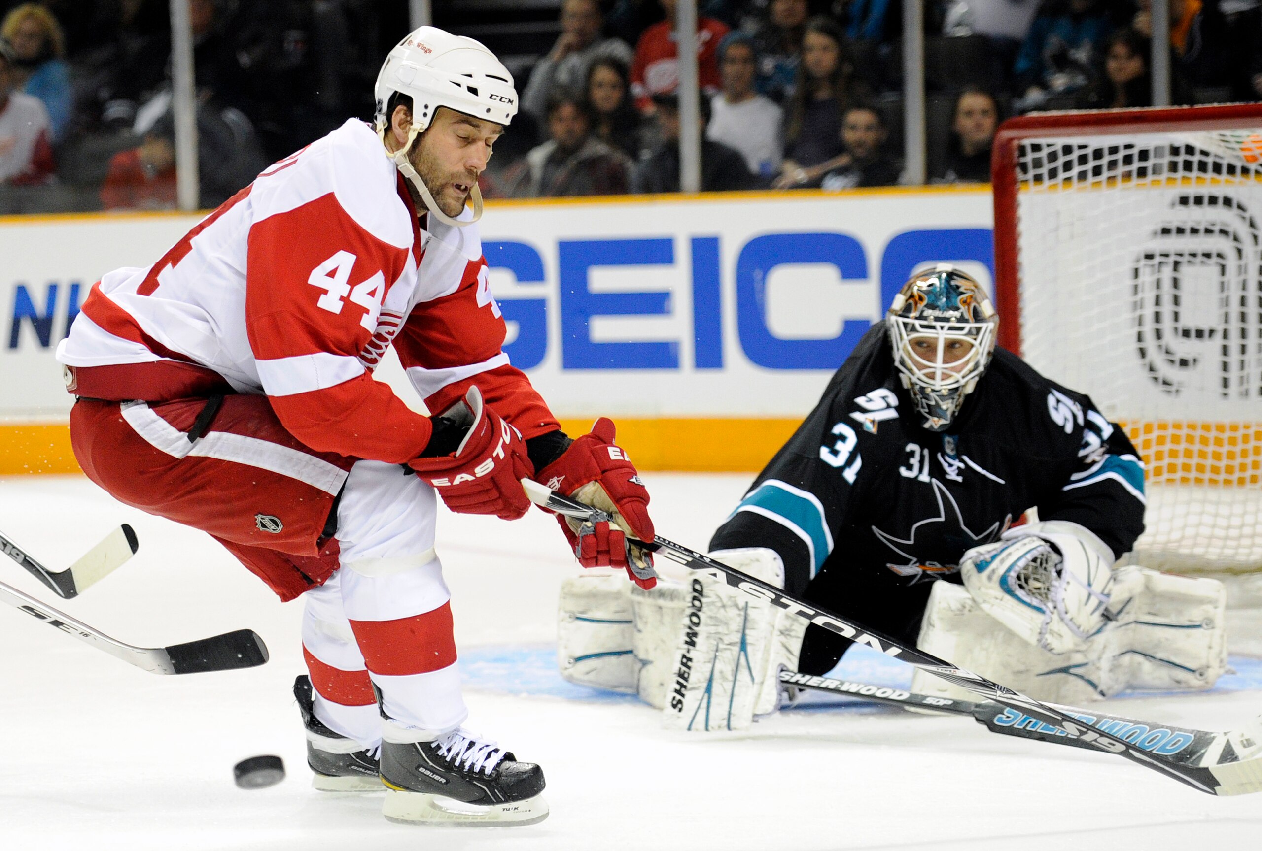 SAN JOSE, CA - MARCH 3: Todd Bertuzzi #44 of the Detroit Red Wings has the puck knocked away by goalie Antti Niemi #31 of the San Jose Sharks in the third period of an NHL hockey game at the HP Pavilion on March 3, 2011 in San Jose, California. The Sharks