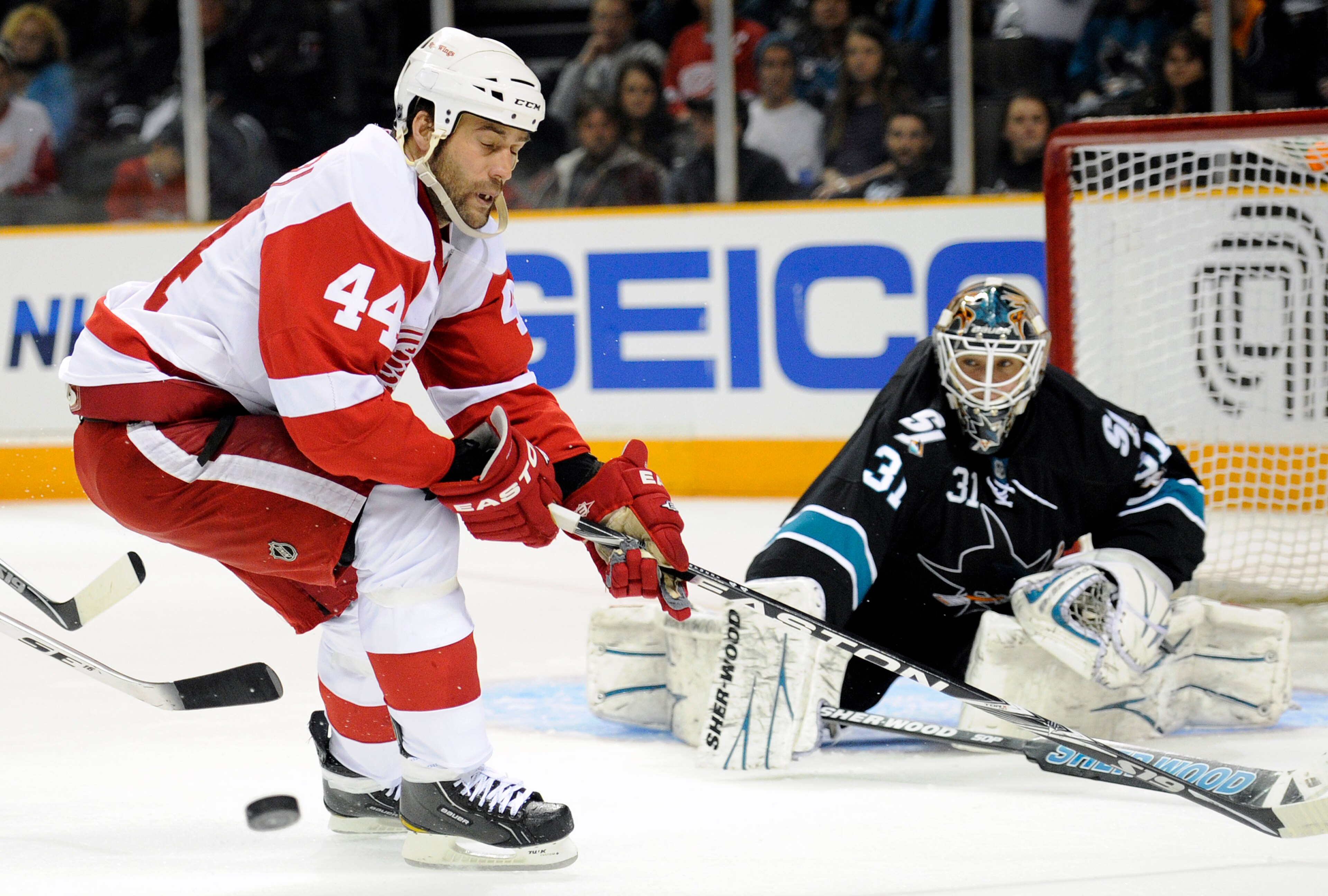 SAN JOSE, CA - MARCH 3: Todd Bertuzzi #44 of the Detroit Red Wings has the puck knocked away by goalie Antti Niemi #31 of the San Jose Sharks in the third period of an NHL hockey game at the HP Pavilion on March 3, 2011 in San Jose, California. The Sharks