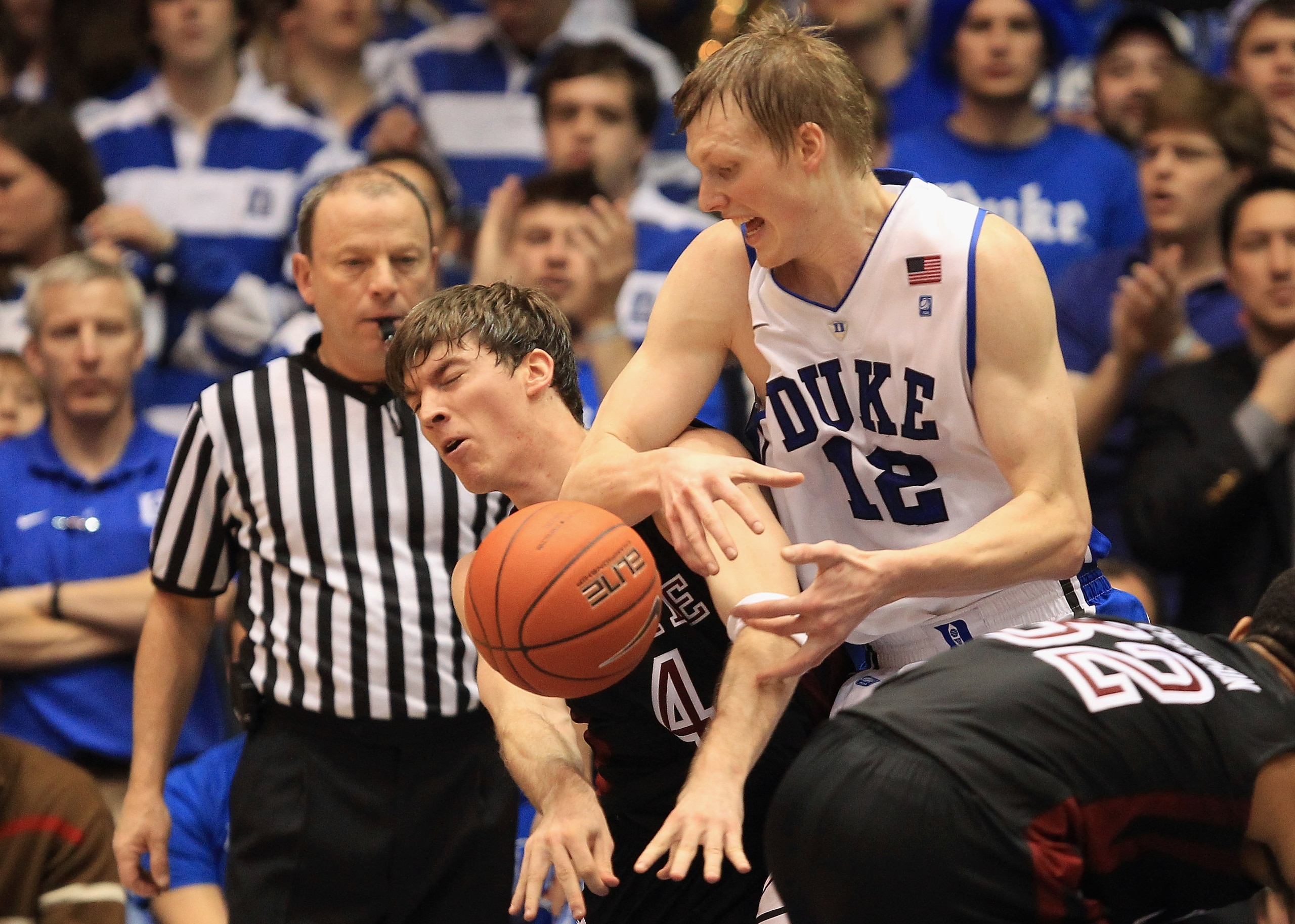 DURHAM, NC - FEBRUARY 23:  Juan Fernandez #4 of the Temple Owls runs into Kyle Singler #12 of the Duke Blue Devils during their game at Cameron Indoor Stadium on February 23, 2011 in Durham, North Carolina.  (Photo by Streeter Lecka/Getty Images)