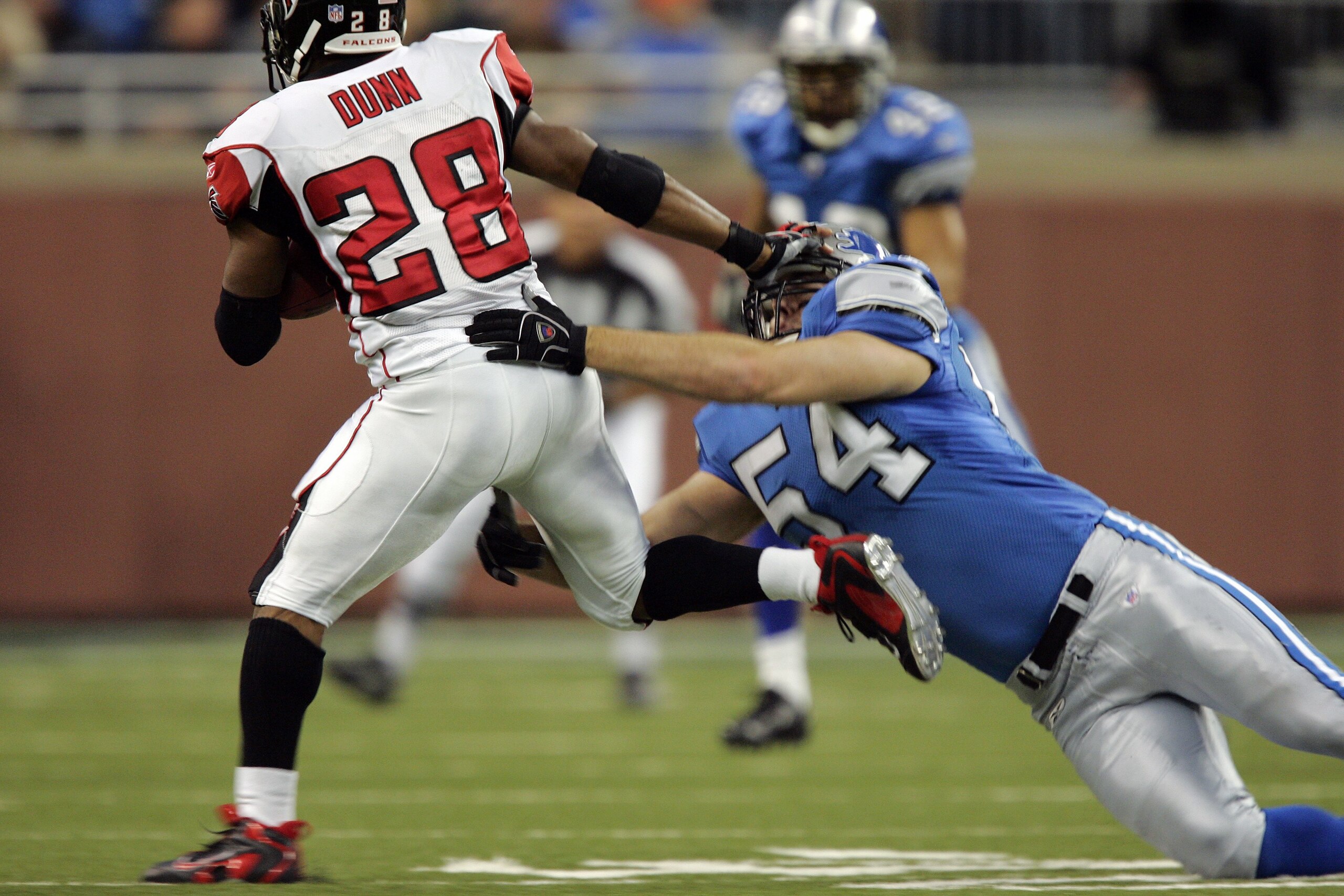 DETROIT - NOVEMBER 05: Running back Warrick Dunn #28 of the Atlanta Falcons gets caught by Teddy Lehman #54 of the Detroit Lions during a 30-14 loss to the Detroit Lions on November 5, 2006 at Ford Field in Detroit, Michigan. (Photo by Brian Bahr/Getty DETROIT - NOVEMBER 05: Running back Warrick Dunn #28 of the Atlanta Falcons gets caught by Teddy Lehman #54 of the Detroit Lions during a 30-14 loss to the Detroit Lions on November 5, 2006 at Ford Field in Detroit, Michigan. (Photo by Brian Bahr/Getty
