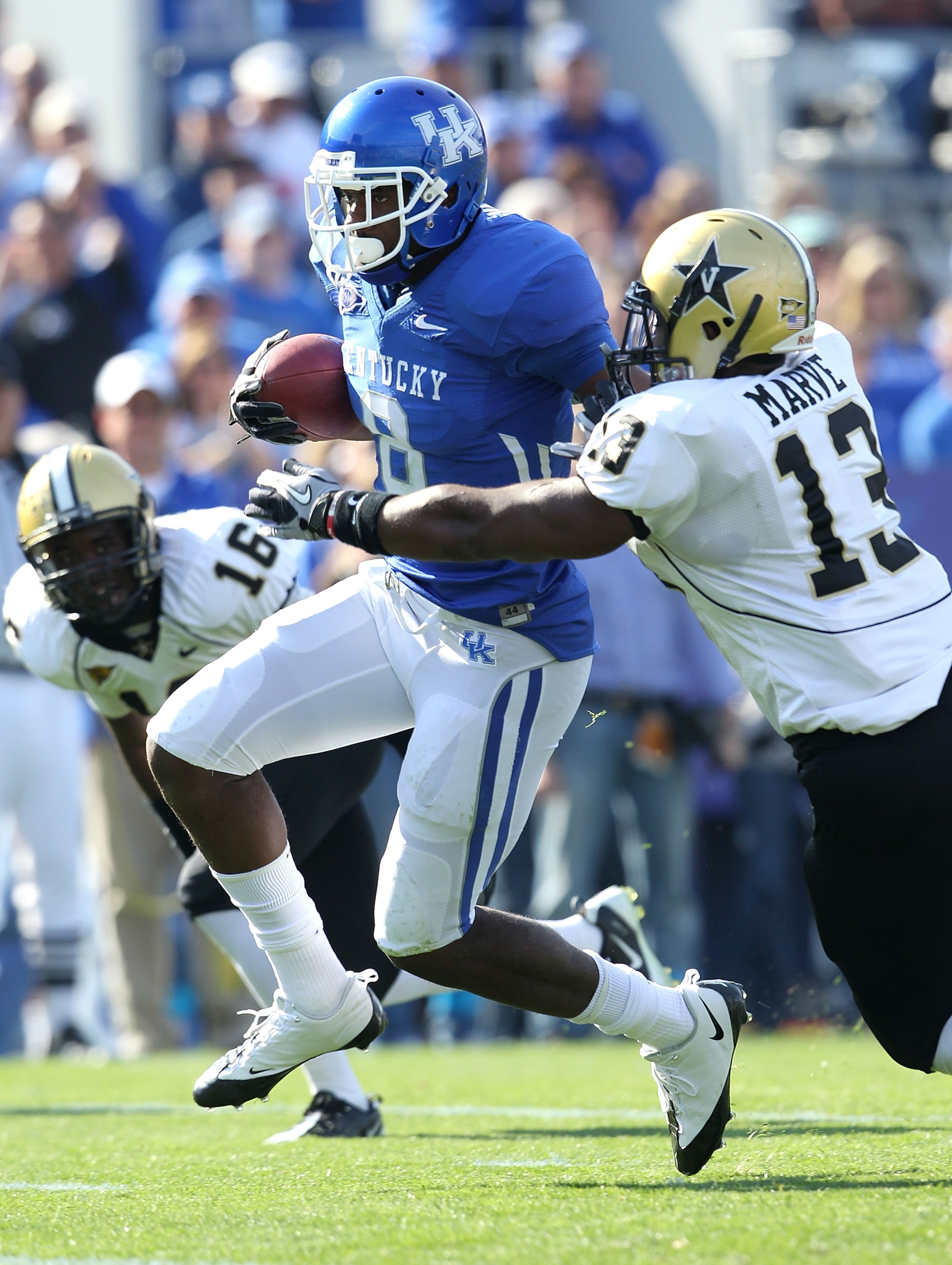 LEXINGTON, KY - NOVEMBER 13:  Chris Matthews #8 of the Kentucky Wildcats runs with the ball while defended by Chris Marve #13 of the Vanderbilt Commodores at Commonwealth Stadium on November 13, 2010 in Lexington, Kentucky.  (Photo by Andy Lyons/Getty Ima