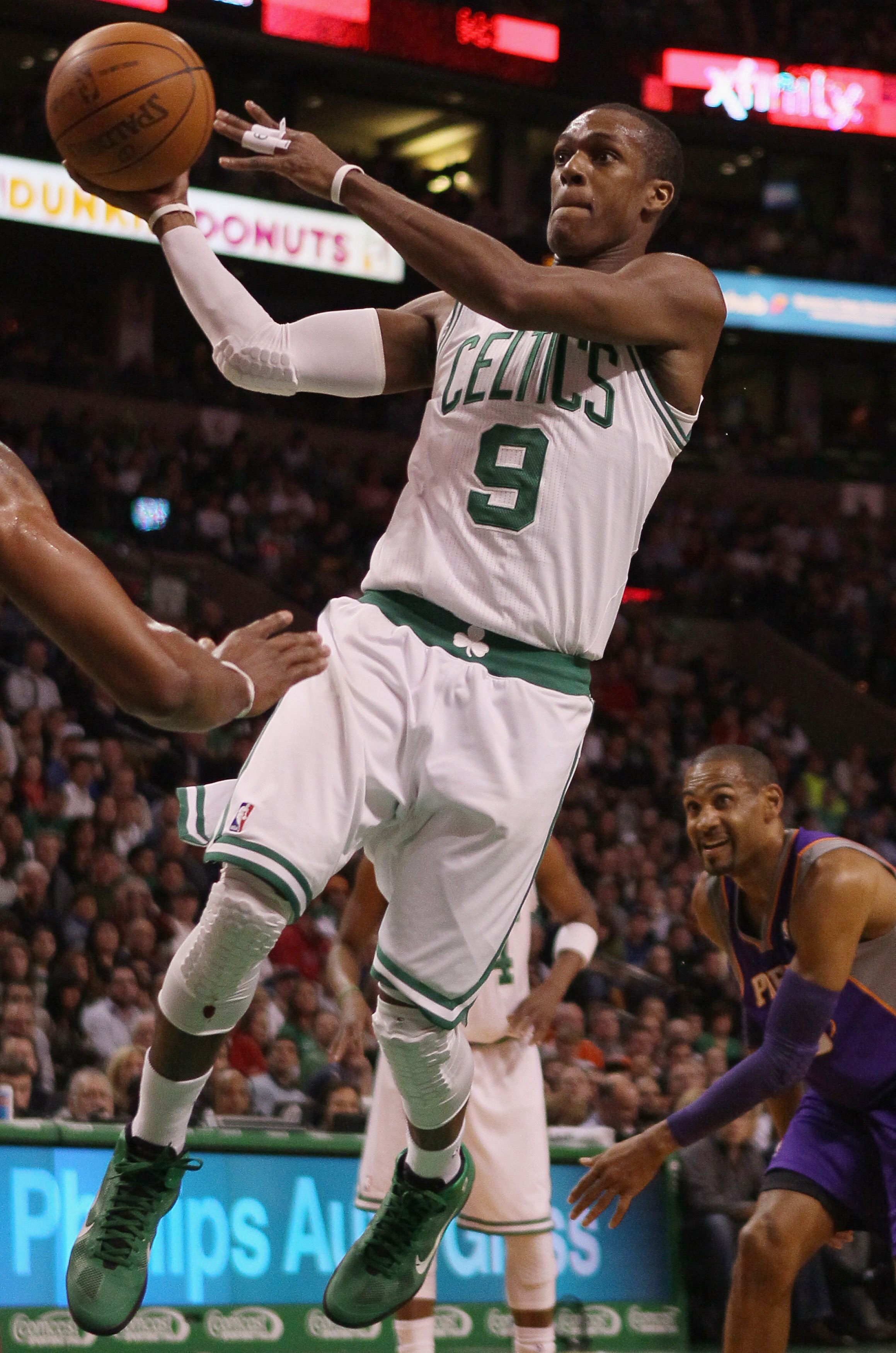 BOSTON, MA - MARCH 02:  Rajon Rondo #9 of the Boston Celtics heads for the basket as Grant Hill #33 of the Phoenix Suns defends on March 2, 2011 at the TD Garden in Boston, Massachusetts.  NOTE TO USER: User expressly acknowledges and agrees that, by down