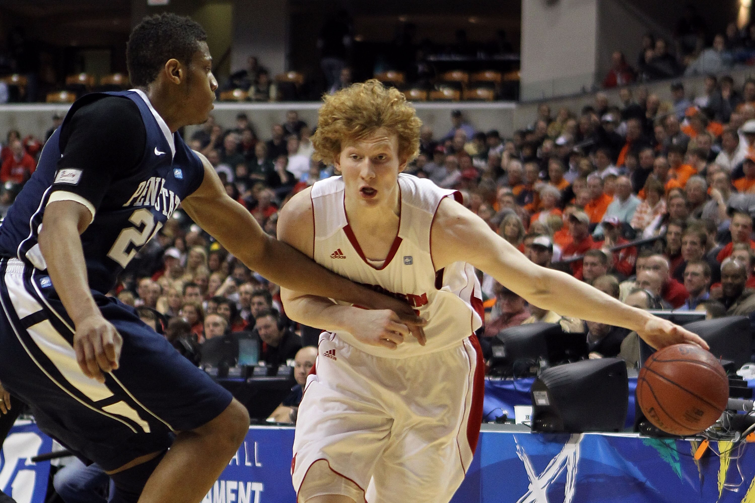 INDIANAPOLIS, IN - MARCH 11:  Mike Bruesewitz #31 of the Wisconsin Badgers drives against Jeff Brooks #25 of the Penn State Nittany Lions during the quarterfinals of the 2011 Big Ten Men's Basketball Tournament at Conseco Fieldhouse on March 11, 2011 in I