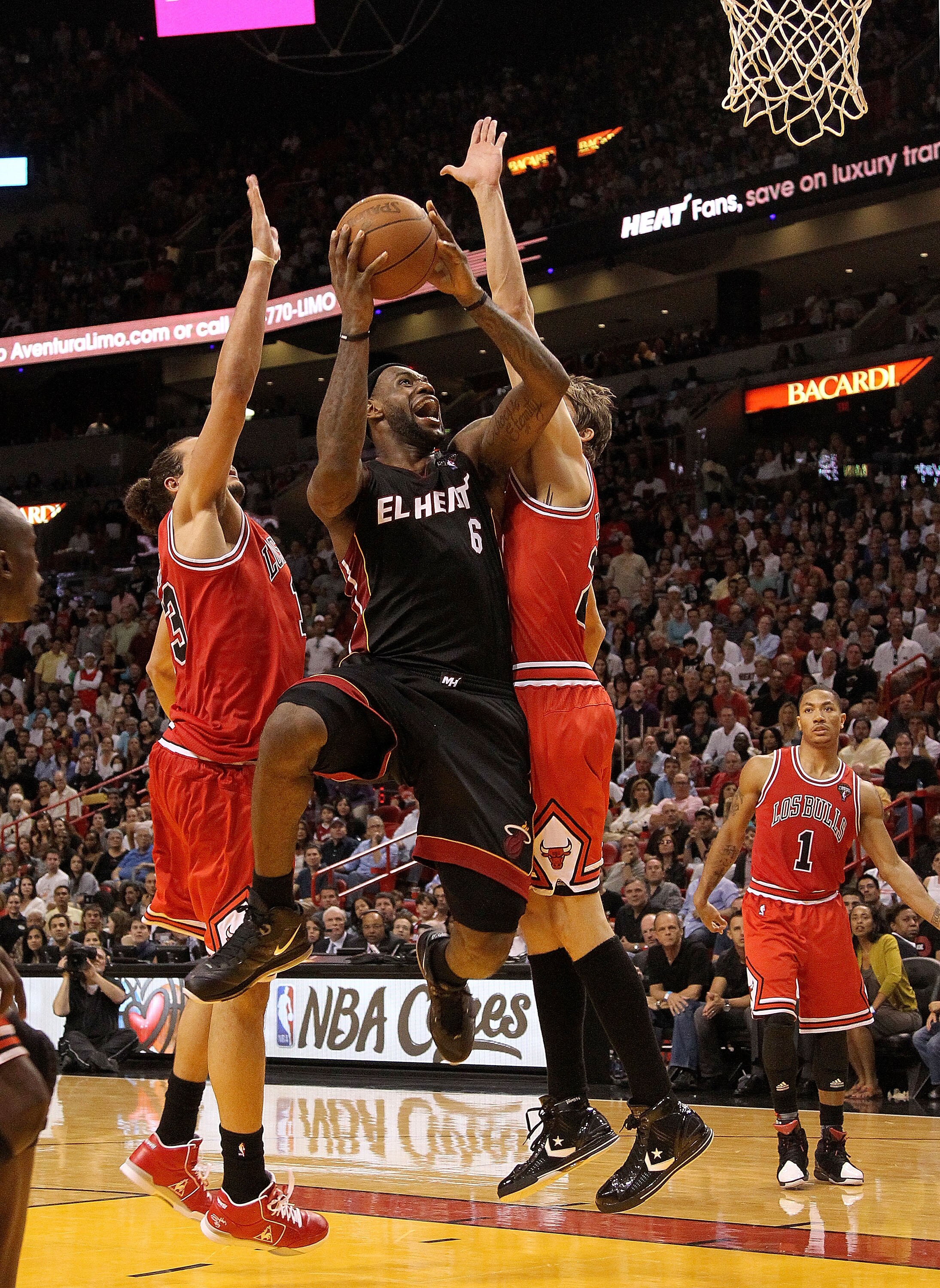 MIAMI, FL - MARCH 06:  LeBron James #6 of the Miami Heat shoots over Joakim Noah #13 and Omer Asik #3 of the Chicago Bulls during a game at American Airlines Arena on March 6, 2011 in Miami, Florida. NOTE TO USER: User expressly acknowledges and agrees th