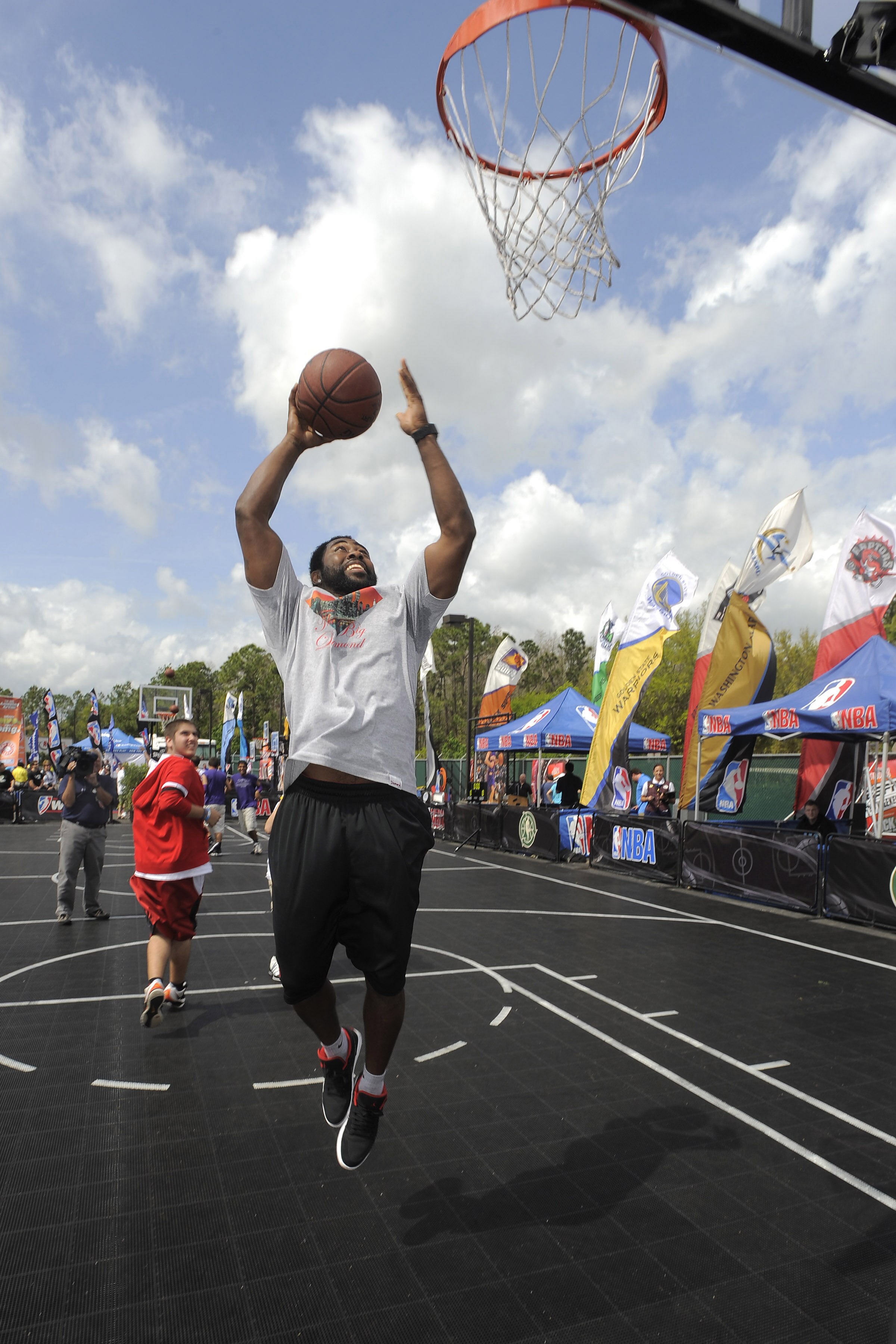 LAKE BUENA VISTA, FL - MARCH 06:  In this handout image provided by Disney Parks, Darrelle Revis, All-Pro NFL defensive back for the New York Jets, goes up for a layup on the basketball court on March 6, 2011 at the ESPN The Weekend special event at Disne