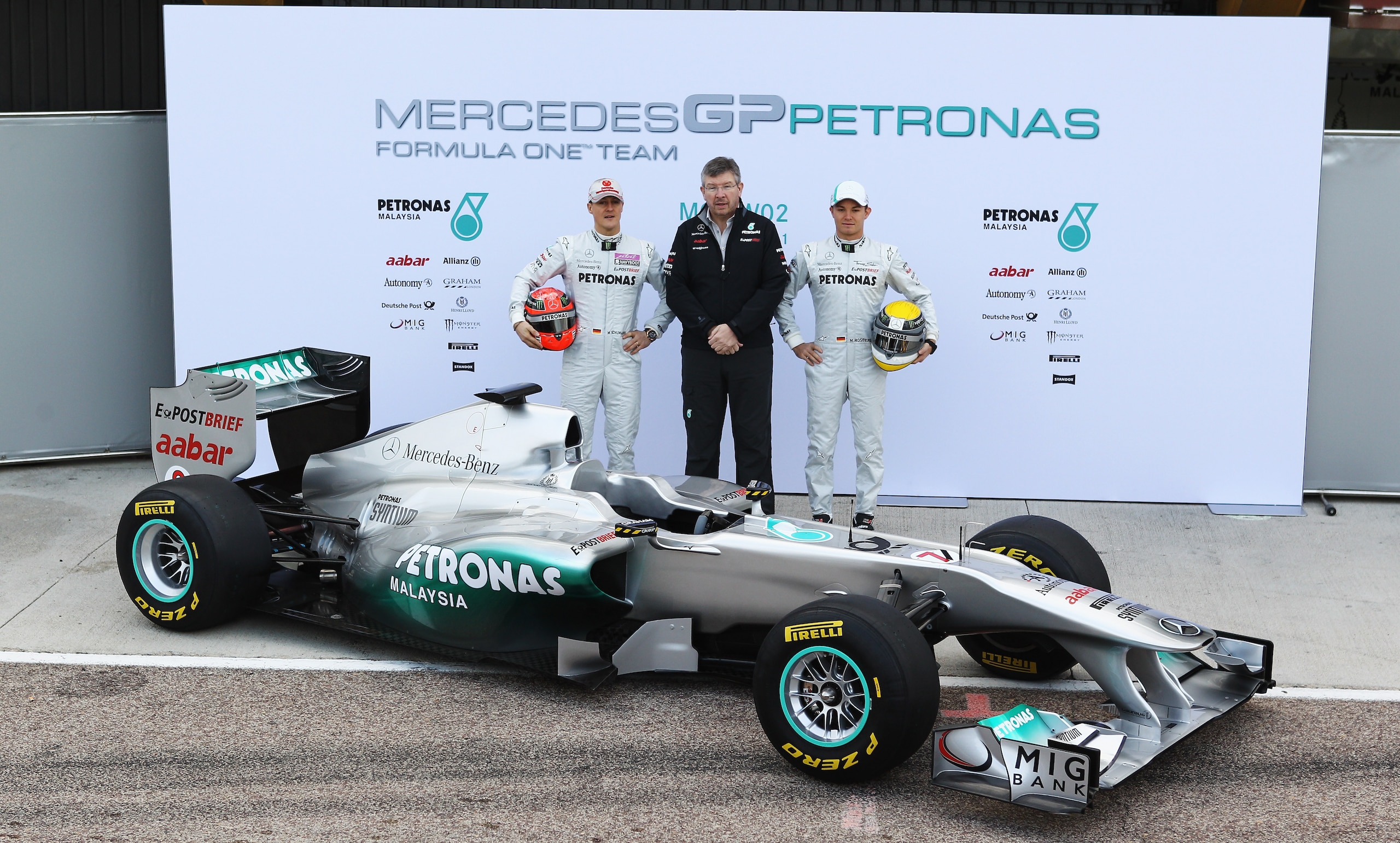 VALENCIA, SPAIN - FEBRUARY 01:  Nico Rosberg (L) of Germany, Michael Schumacher (R) of Germany and Mercedes GP Team Principal Ross Brawn (C) attend the unveiling of the new Mercedes MGP W02 at the Ricardo Tormo Circuit on February 1, 2011 in Valencia, Spa