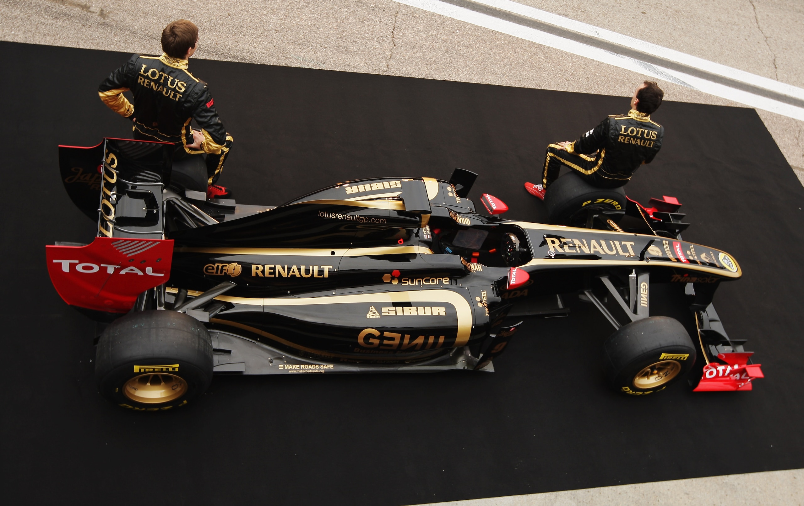 VALENCIA, SPAIN - JANUARY 31:  Robert Kubica (R) of Poland and Vitaly Petrov (L) of Russia attend the unveiling of the new Lotus Renault GP R31 at the Ricardo Tormo Circuit on January 31, 2011 in Valencia, Spain.  (Photo by Ker Robertson/Getty Images)