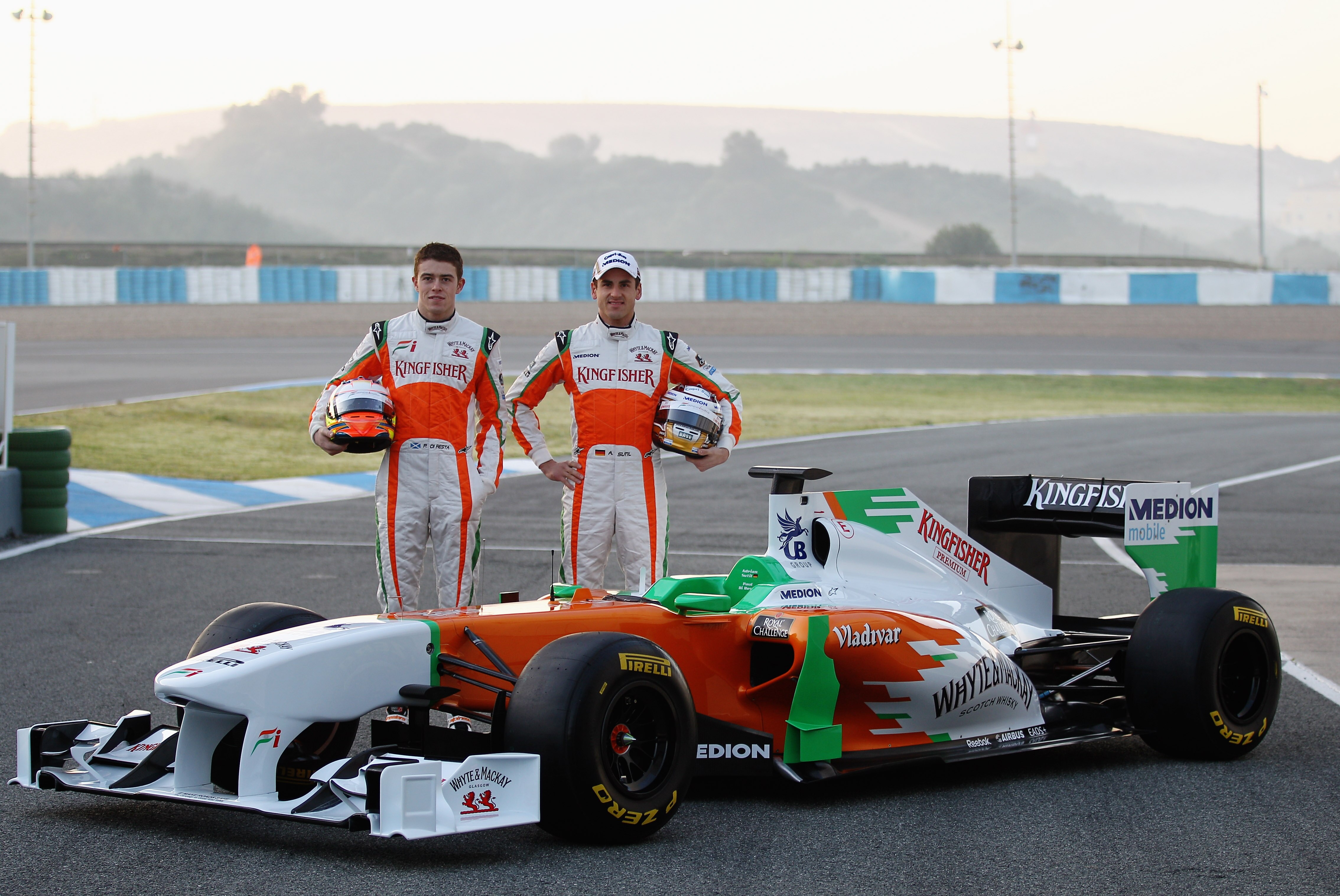 JEREZ DE LA FRONTERA, SPAIN - FEBRUARY 10:  Adrian Sutil of Germany and Force India and Paul di Resta of Great Britain and Force India pose at the launch of the new Force India VJM04 car during day one of winter testing at the Circuito de Jerez on Februar
