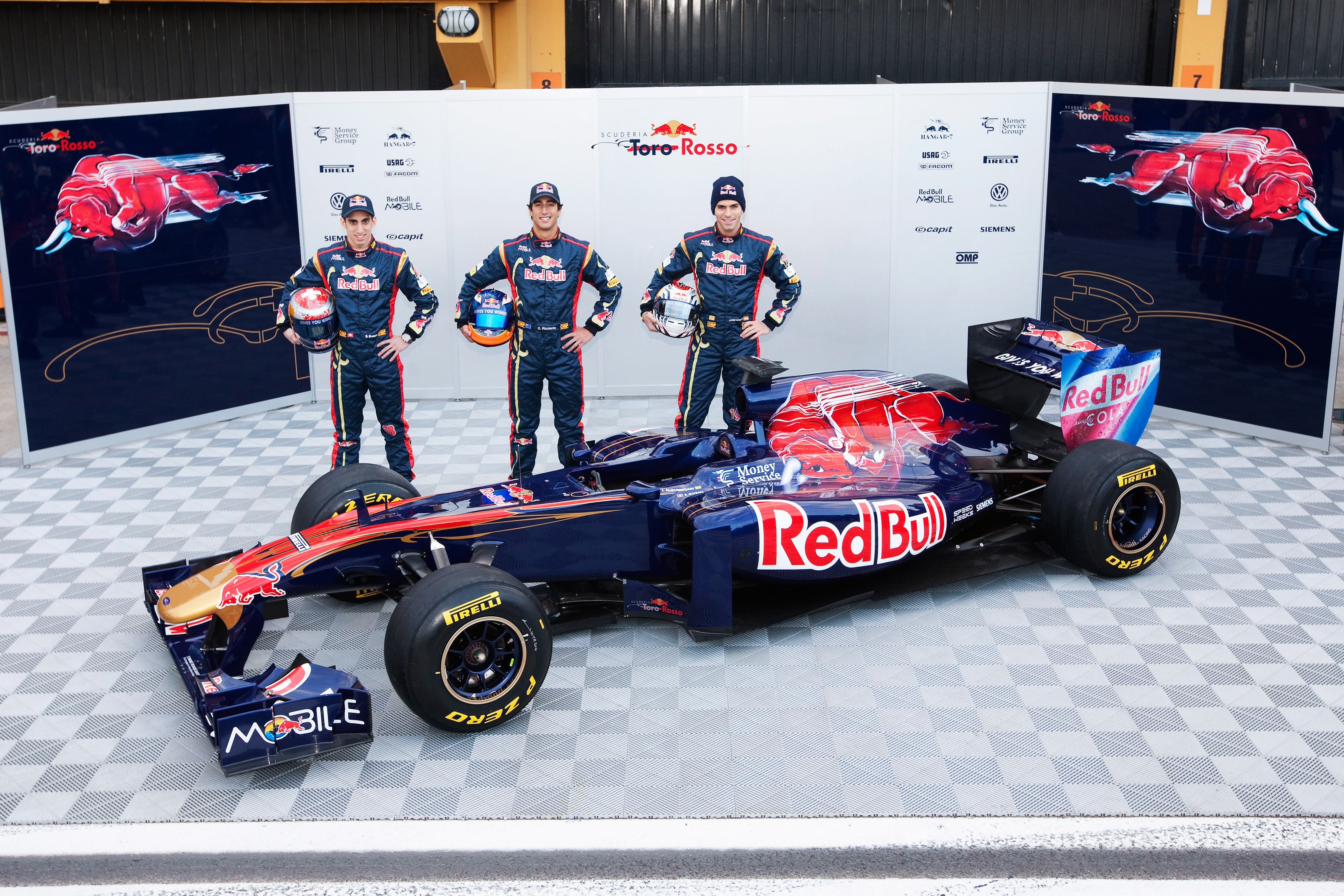 VALENCIA, SPAIN - FEBRUARY 01:  Drivers Jaime Alguersuari (R) of Spain, Sebastien Buemi (L) of Switzerland and reserve driver Daniel Ricciardo (C) of Australia attend the unveiling of the new Scuderia Toro Rosso STR6 at the Ricardo Tormo Circuit on Februa