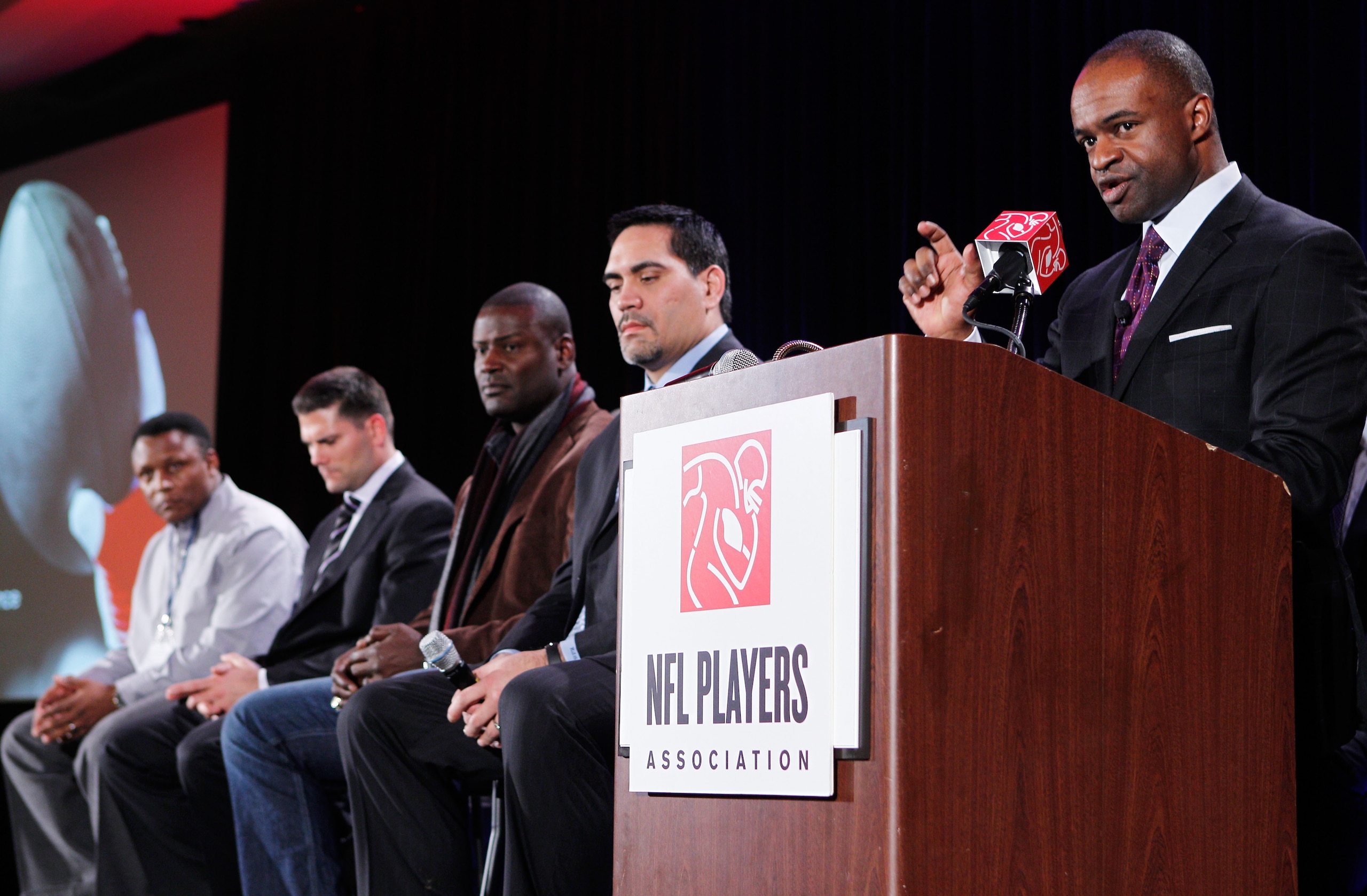 DALLAS, TX - FEBRUARY 03:  NFLPA executive director DeMaurice Smith (R) speaks as players look on during the NFL Players Association press conference at the Super Bowl XLV media center on February 3, 2011 in Dallas, Texas. The Green Bay Packers will play