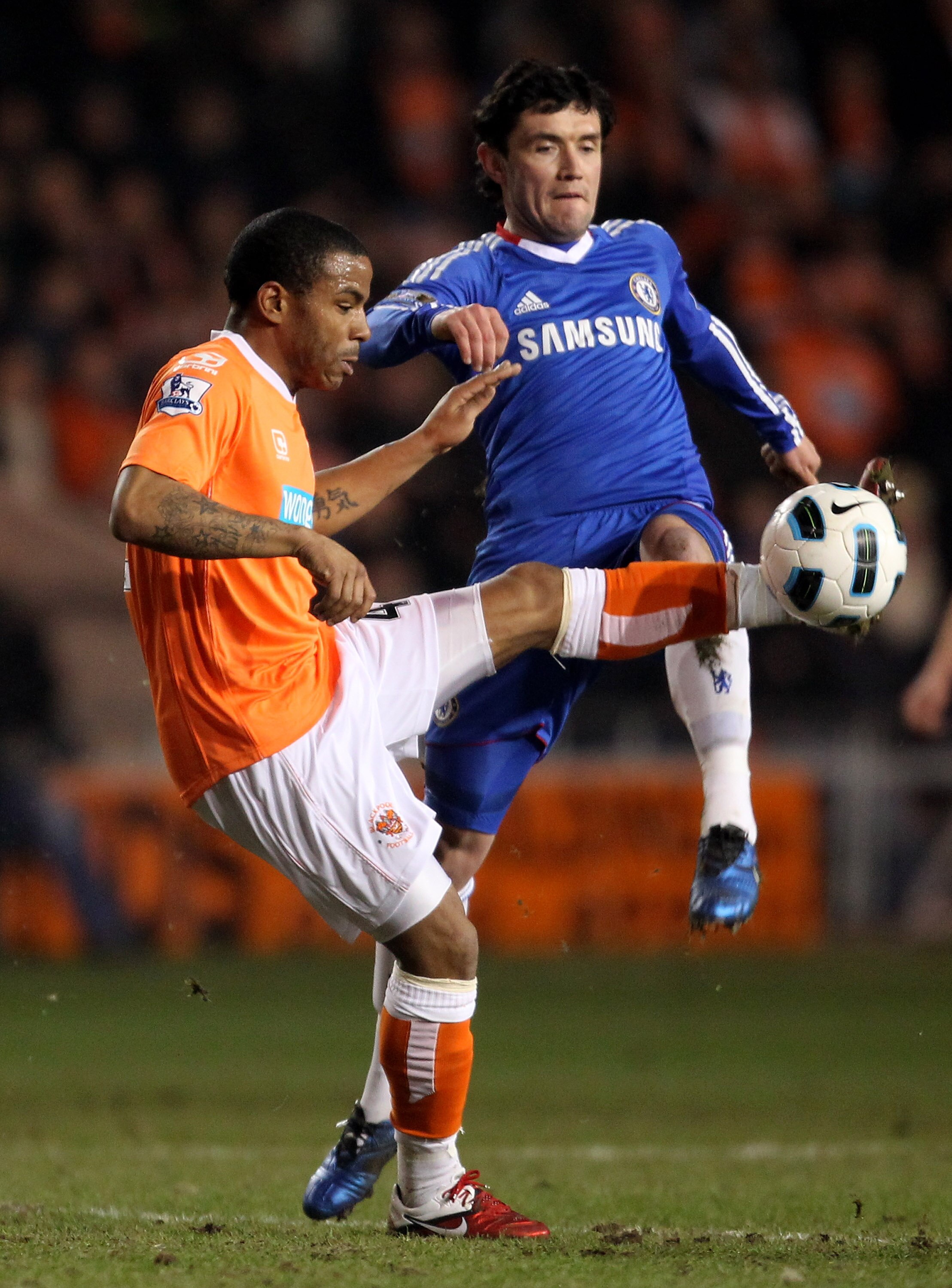 BLACKPOOL, ENGLAND - MARCH 07:  Yuri Zhirkov of Chelsea competes with Jason Puncheon of Blackpool during the Barclays Premiership match between Blackpool and Chelsea at Bloomfield Road on March 7, 2011 in Blackpool, England. (Photo by Alex Livesey/Getty I