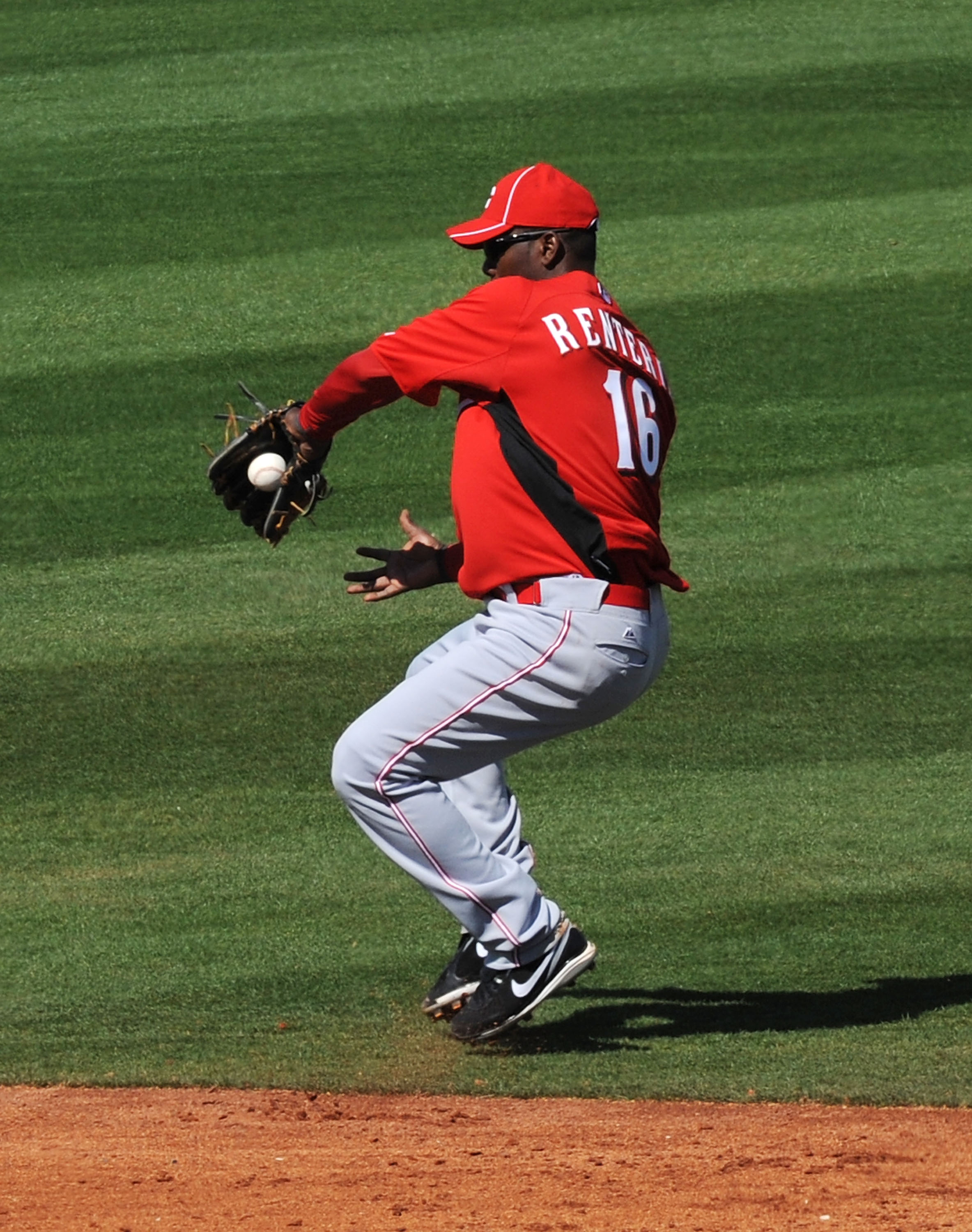 GOODYEAR, AZ - FEBRUARY 27:  Edgar Renteria #16 of the Cincinnati Reds makes a backhanded play on a ground ball against the Cleveland Indians at Goodyear Ballpark on February 27, 2011 in Goodyear, Arizona.  (Photo by Norm Hall/Getty Images)