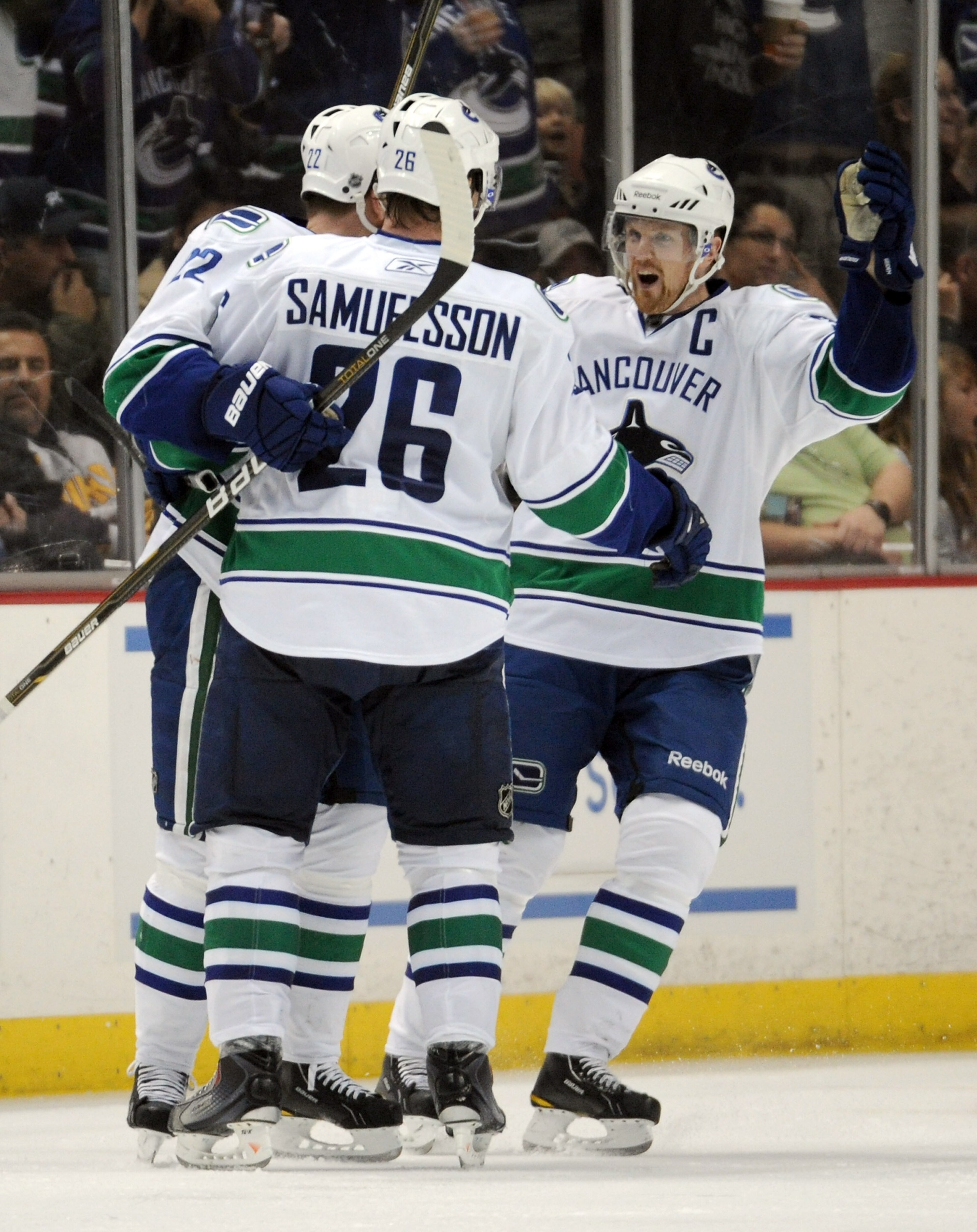 ANAHEIM, CA - MARCH 06:  Henrik Sedin #33 of the Vancouver Canucks celebrates the goal of Daniel Sedin #22 with Mikael Samuelsson #26 for a 3-0 lead over the Anaheim Ducks at the Honda Center on March 6, 2011 in Anaheim, California.  (Photo by Harry How/G