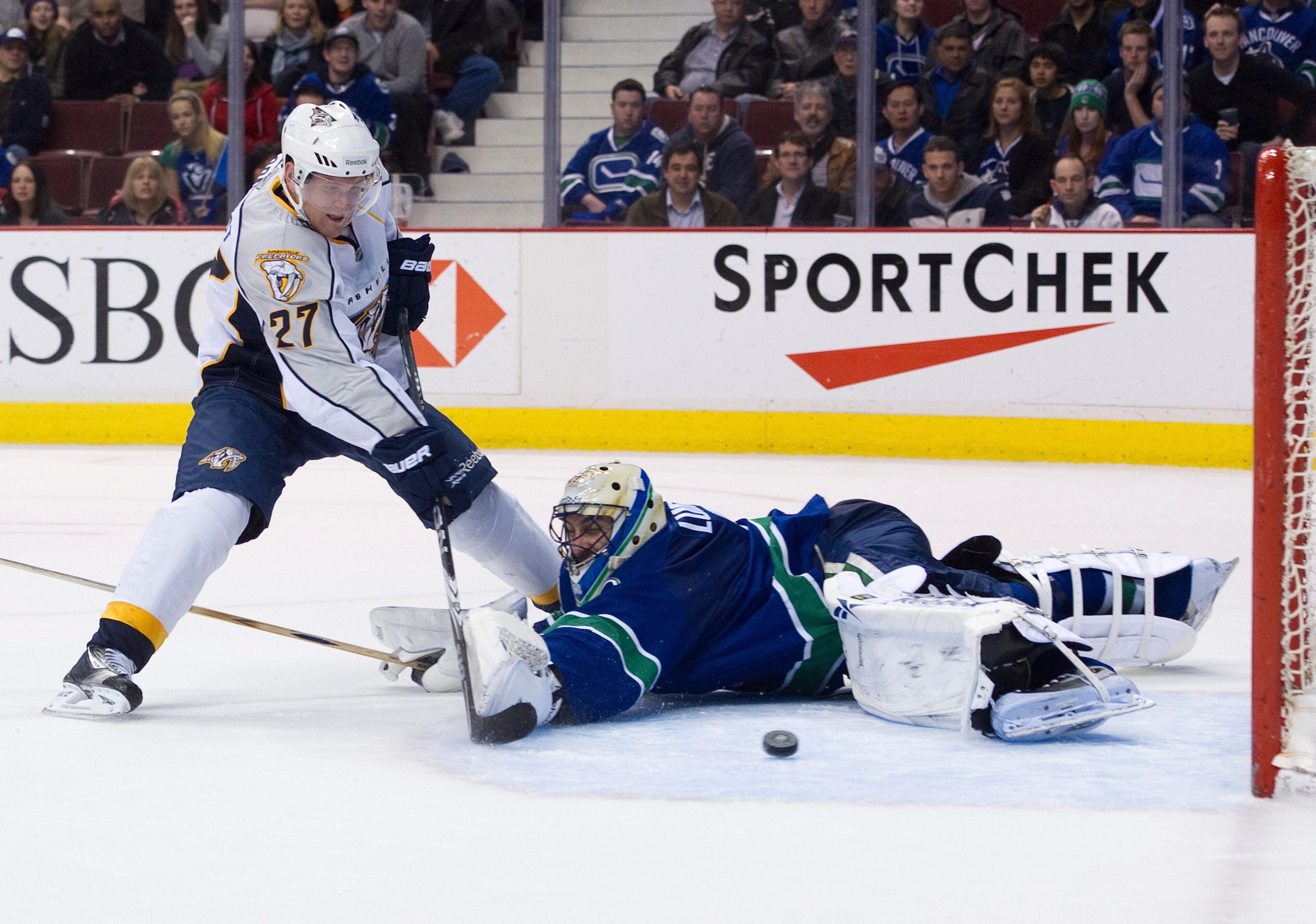 VANCOUVER, CANADA - MARCH 3: Patric Hornqvist #27 of the Nashville Predators slides the puck past goalie Roberto Luongo #1 of the Vancouver Canucks during the third period in NHL action on March 03, 2011 at Rogers Arena in Vancouver, British Columbia, Can