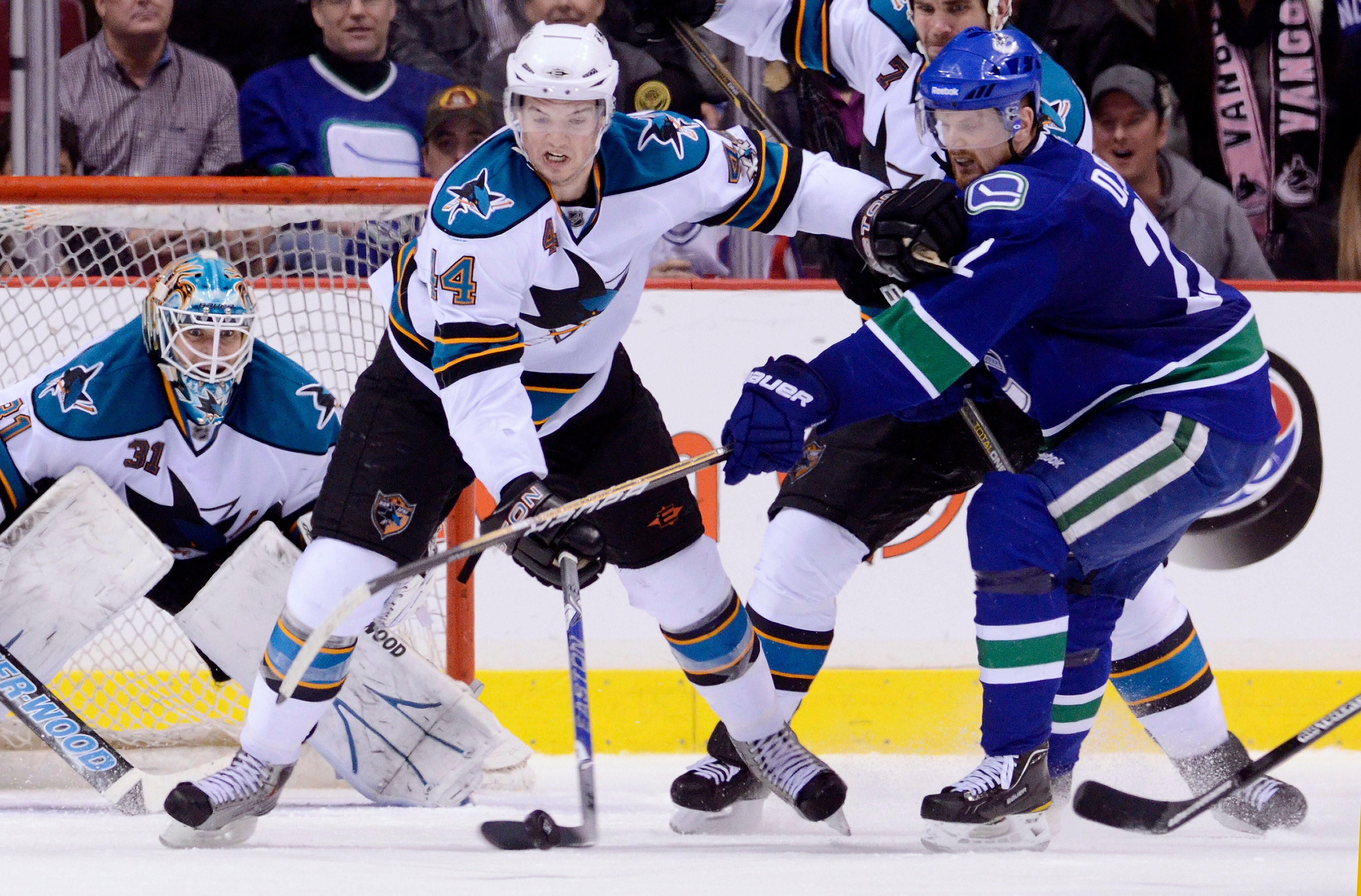 VANCOUVER, CANADA - JANUARY 20: Marc-Edouard Vlasic #44 of the San Jose Sharks holds off Daniel Sedin #22 of the Vancouver Canucks while trying to clear the puck during the third period in NHL action on January 20, 2011 at Rogers Arena in Vancouver, BC, C VANCOUVER, CANADA - JANUARY 20: Marc-Edouard Vlasic #44 of the San Jose Sharks holds off Daniel Sedin #22 of the Vancouver Canucks while trying to clear the puck during the third period in NHL action on January 20, 2011 at Rogers Arena in Vancouver, BC, C