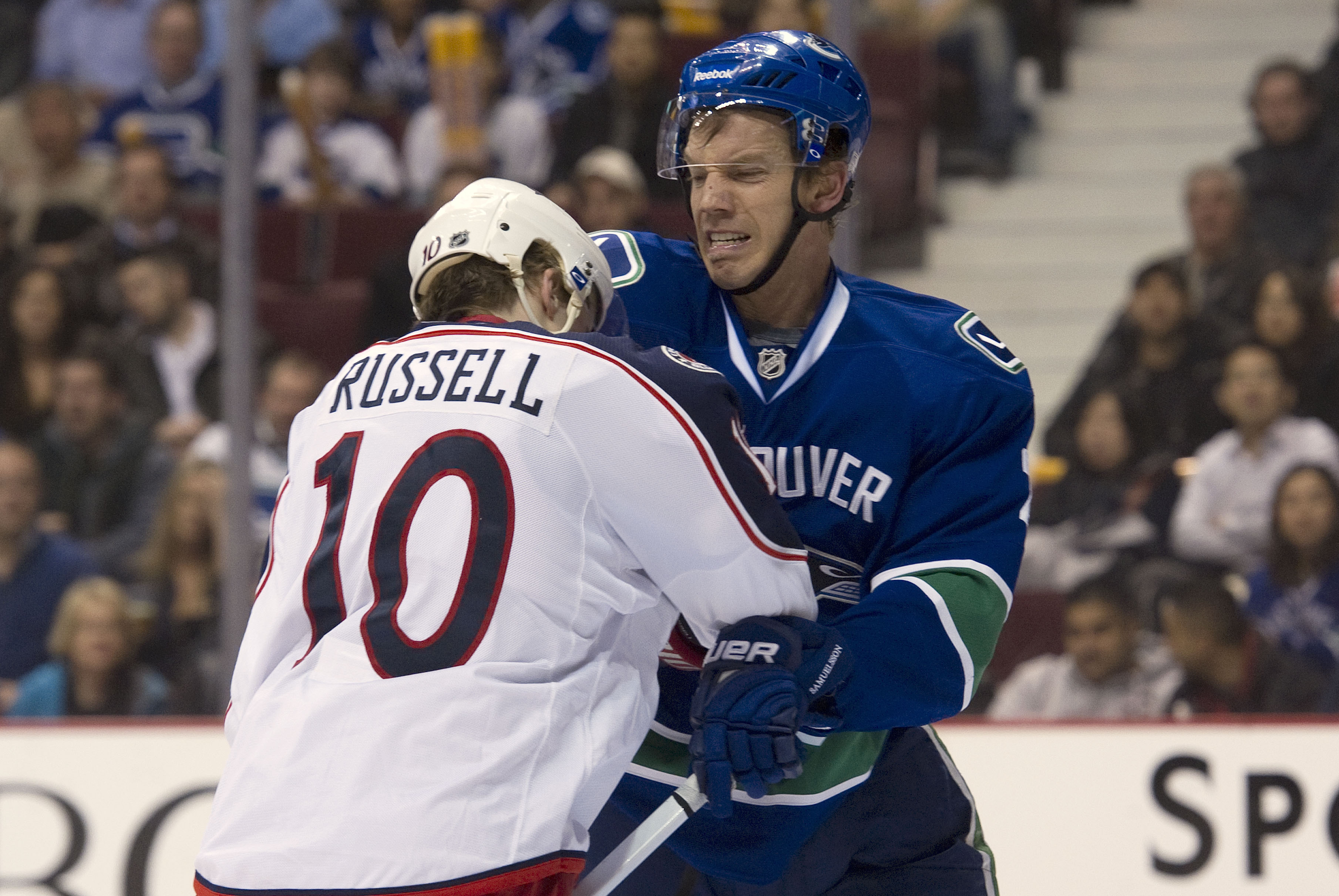 VANCOUVER, CANADA - MARCH 1: Mikael Samuelsson #26 of the Vancouver Canucks punched Kris Russell #10 of the Columbus Blue Jackets while battling in front of the net during the second period in NHL action on March 01, 2011 at Rogers Arena in Vancouver, Bri VANCOUVER, CANADA - MARCH 1: Mikael Samuelsson #26 of the Vancouver Canucks punched Kris Russell #10 of the Columbus Blue Jackets while battling in front of the net during the second period in NHL action on March 01, 2011 at Rogers Arena in Vancouver, Bri