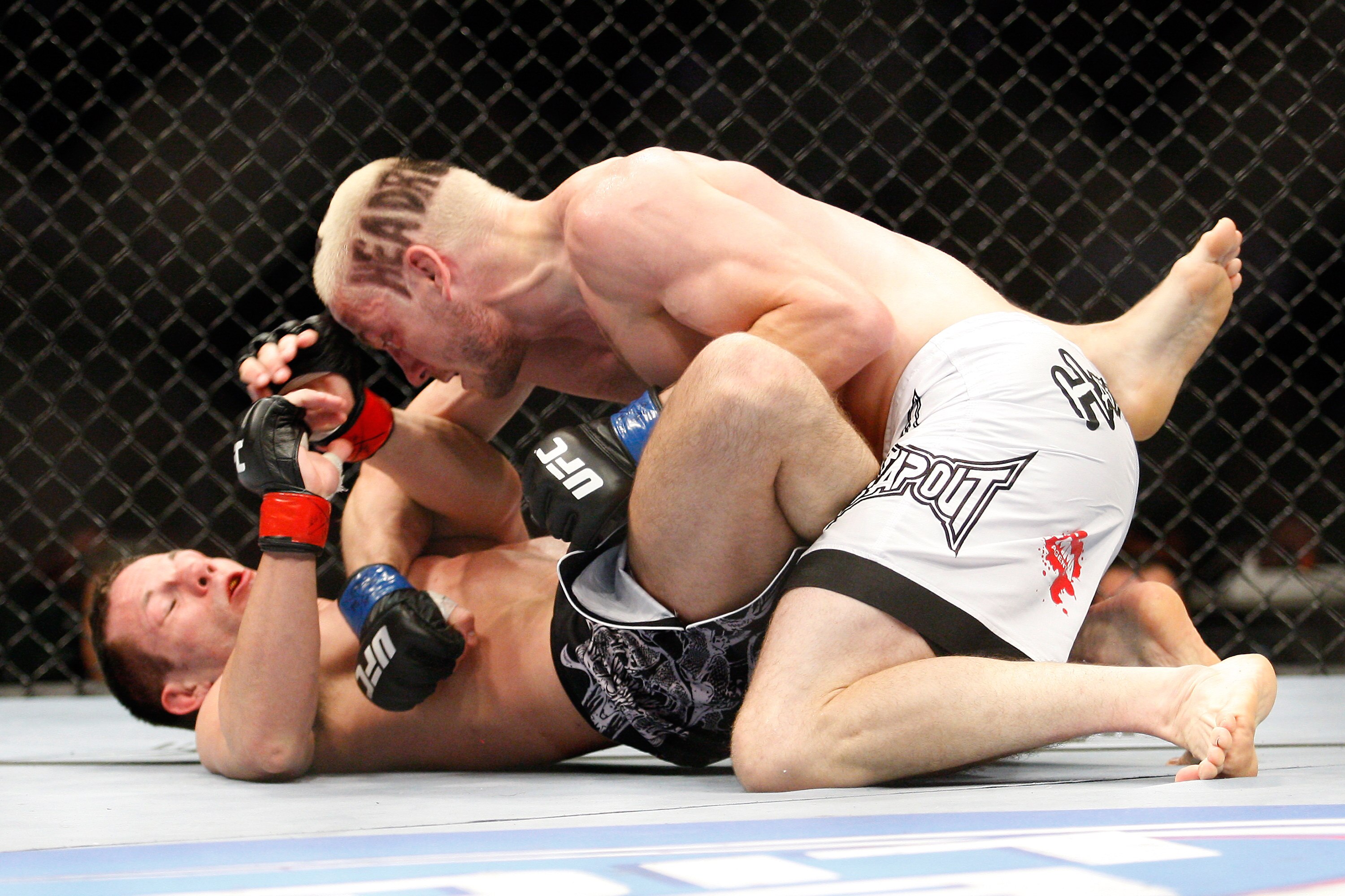 MONTREAL- MAY 8: Jonathan Goulet (top) punches Marcus Davis in their welterweight bout at UFC 113 at Bell Centre on May 8, 2010 in Montreal, Quebec, Canada.  (Photo by Richard Wolowicz/Getty Images)