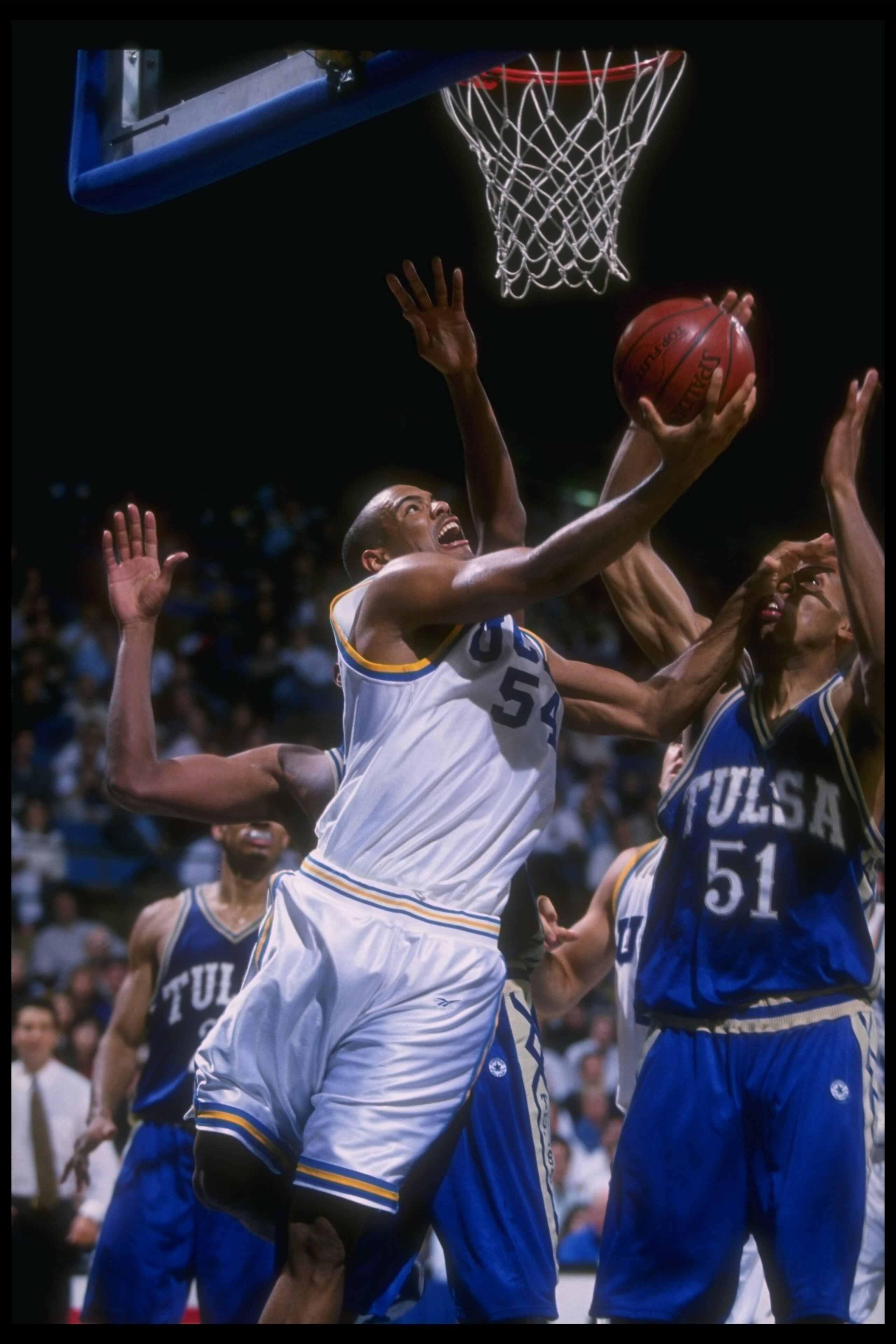 20 Nov 1996:  Guard Kris Johnson of the UCLA Bruins (left) goes up for two as Tulsa Golden Hurricane forward Michael Ruffin (right) covers him during a game at Pauley Pavilion in Los Angeles, California.  Tulsa won the game, 77-76. Mandatory Credit: Brian