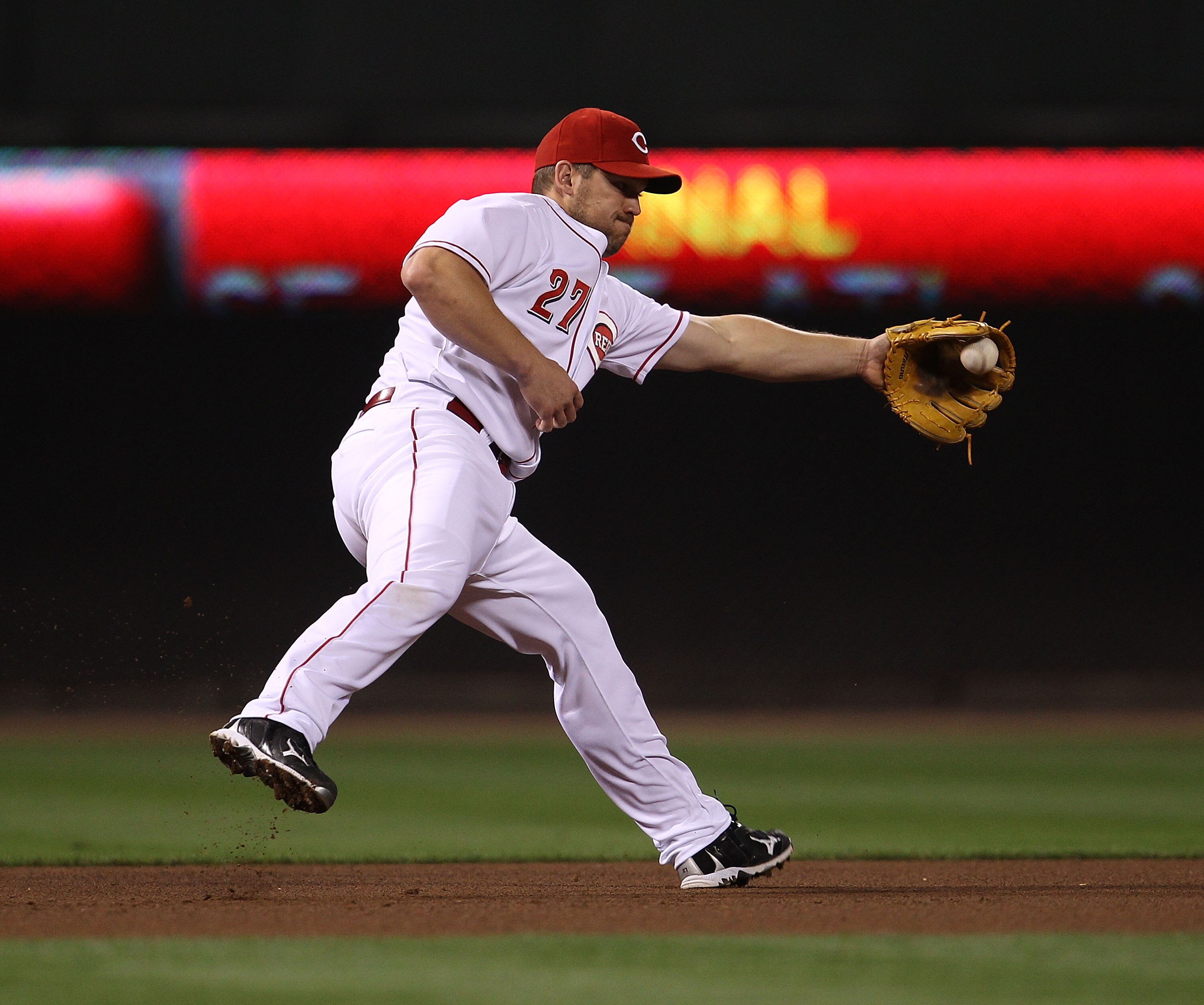 CINCINNATI - OCTOBER 10: Scott Rolen #27 of the Cincinnati Reds fields the ball against the Philadelphia Phillies during game 3 of the NLDS at Great American Ball Park on October 10, 2010 in Cincinnati, Ohio. The Phillies defeated the Reds 2-0. (Photo by