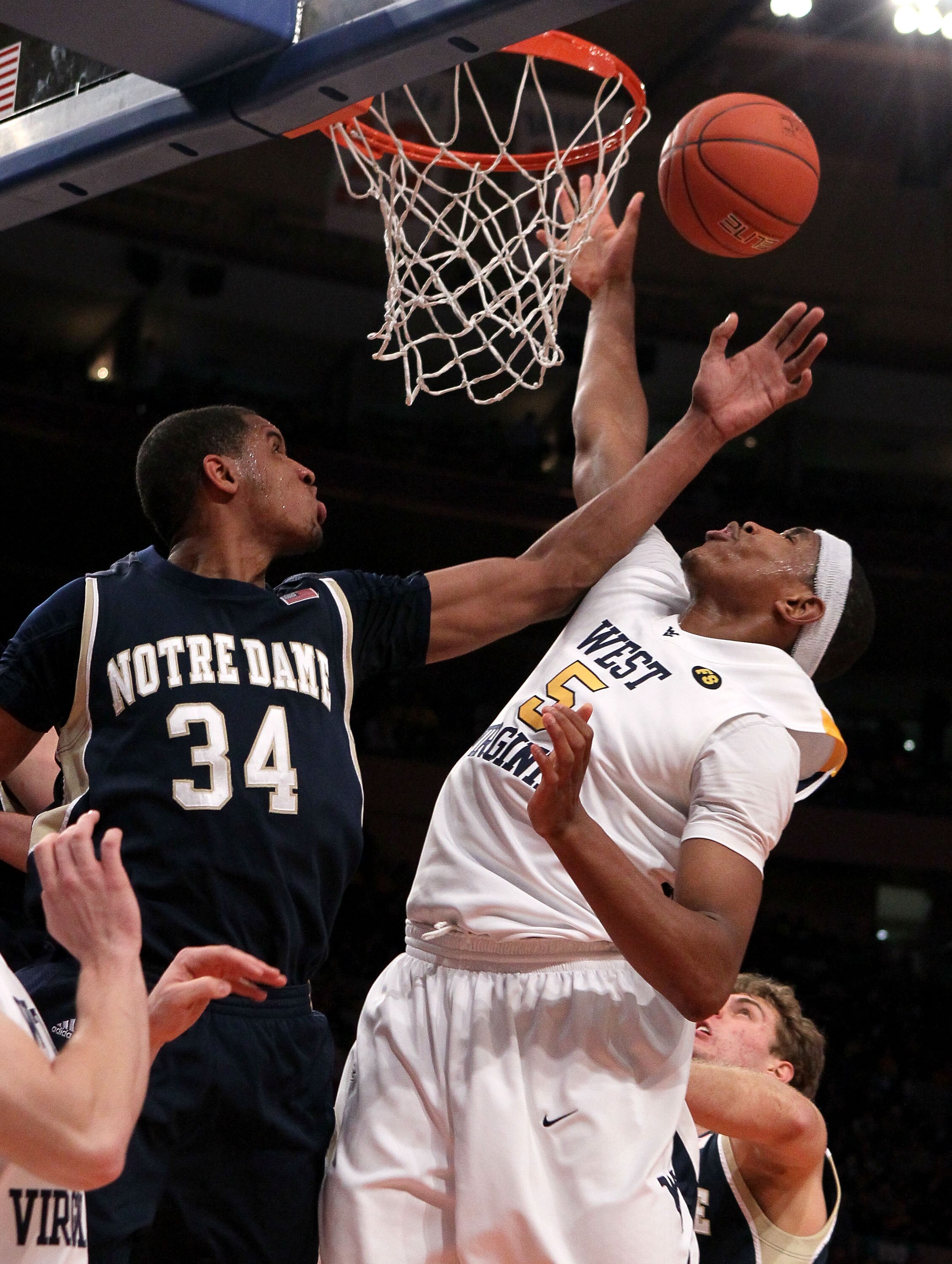 NEW YORK - MARCH 12: Kevin Jones #5 of the West Virginia Mountaineers goes to the hoop against Carleton Scott #34 of the Notre Dame Fighting Irish during the semifinal of the 2010 Big East Tournament at Madison Square Garden on March 12, 2010 in New York