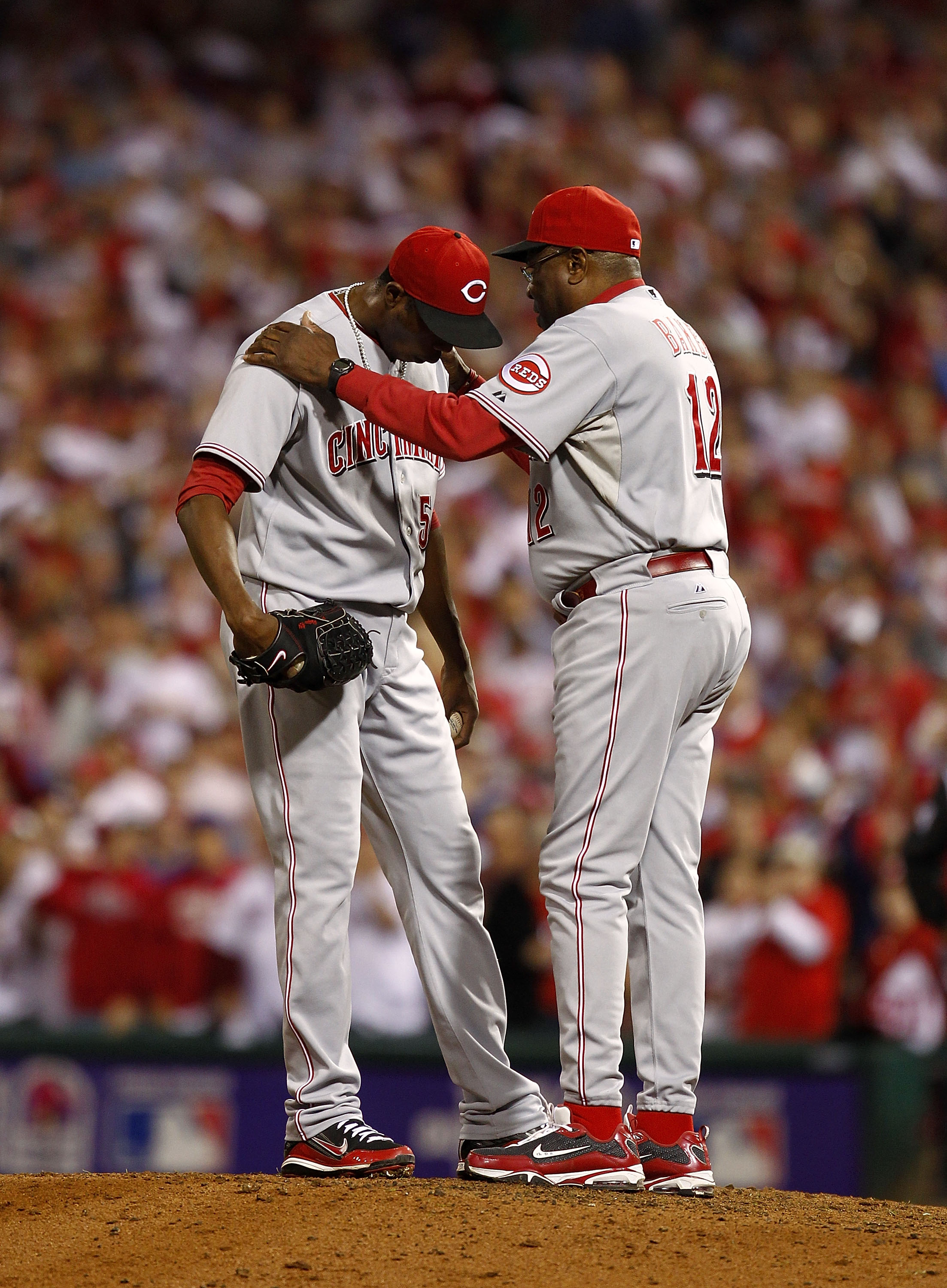 PHILADELPHIA - OCTOBER 08:  Dusty Baker #12 talks with Aroldis Chapman #54 of the Cincinnati Reds in Game 2 of the NLDS against the Philadelphia Phillies at Citizens Bank Park on October 8, 2010 in Philadelphia, Pennsylvania.  (Photo by Jeff Zelevansky/Ge
