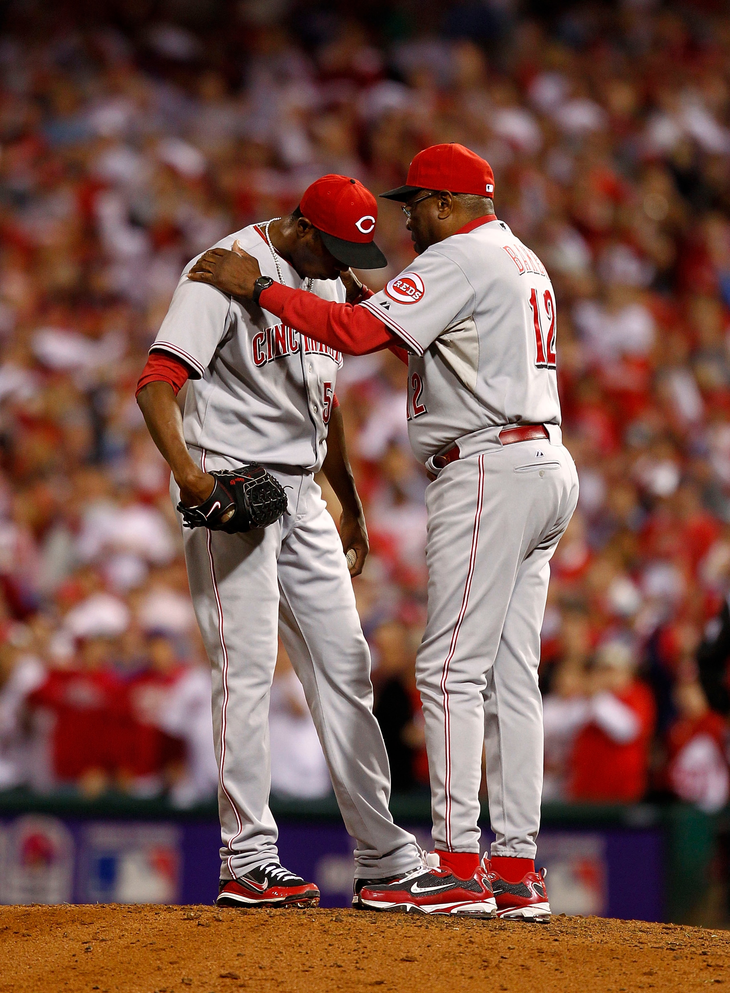 PHILADELPHIA - OCTOBER 08:  Dusty Baker #12 talks with Aroldis Chapman #54 of the Cincinnati Reds in Game 2 of the NLDS against the Philadelphia Phillies at Citizens Bank Park on October 8, 2010 in Philadelphia, Pennsylvania.  (Photo by Jeff Zelevansky/Ge