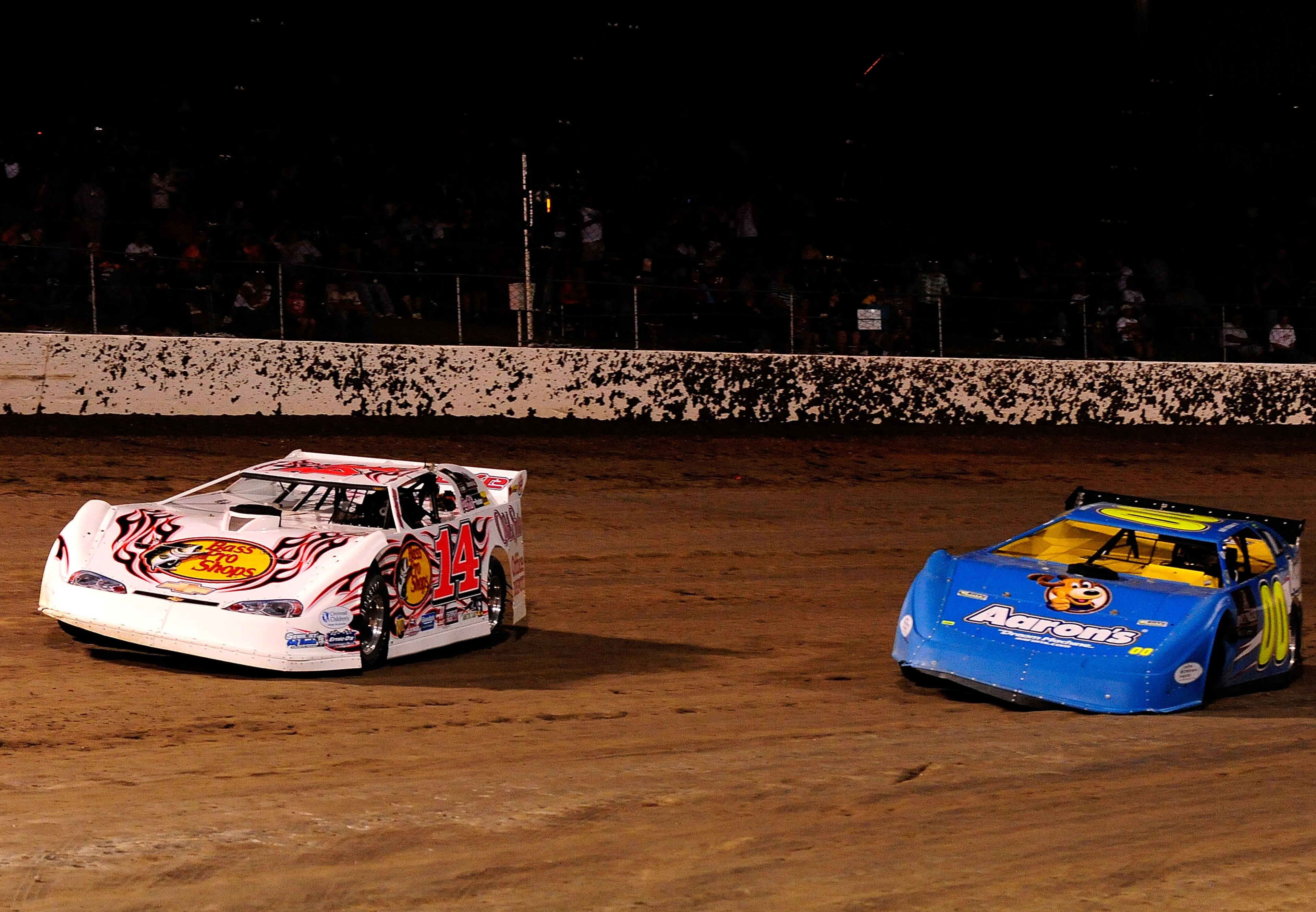 ROSSBURG, OH - JUNE 09: Tony Stewart, driver of the #14 Bass Pro Shops late model Chevrolet, passes David Reutimann, driver of the #00 Aaron's late model Toyota, after Reutimann lost a left front wheel during the Gillette Fusion ProGlide Prelude to the Dr ROSSBURG, OH - JUNE 09: Tony Stewart, driver of the #14 Bass Pro Shops late model Chevrolet, passes David Reutimann, driver of the #00 Aaron's late model Toyota, after Reutimann lost a left front wheel during the Gillette Fusion ProGlide Prelude to the Dr