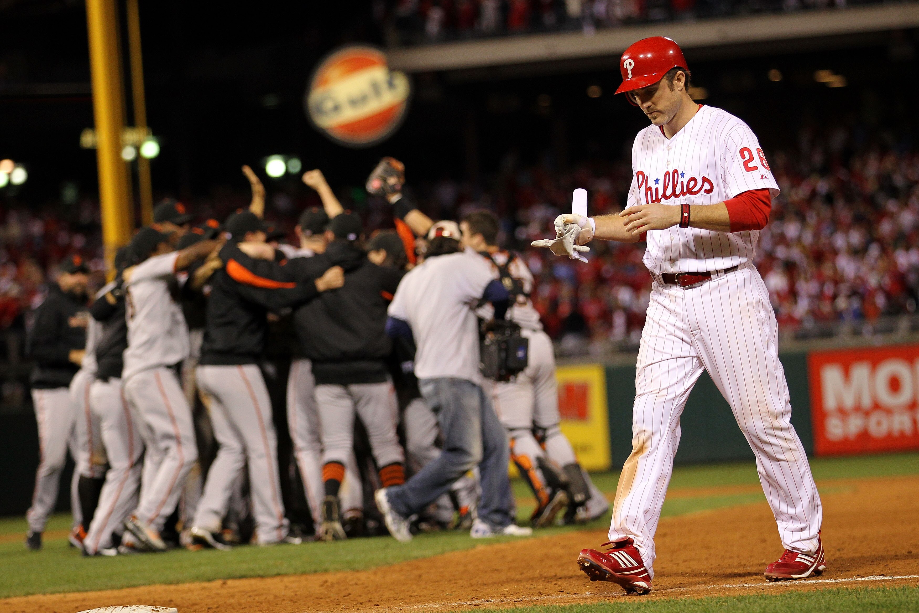 PHILADELPHIA - OCTOBER 23:  Chase Utley #26 of the Philadelphia Phillies walks off the field as the San Francisco Giants celebrate winning 3-2 to win the pennant in Game Six of the NLCS during the 2010 MLB Playoffs at Citizens Bank Park on October 23, 201