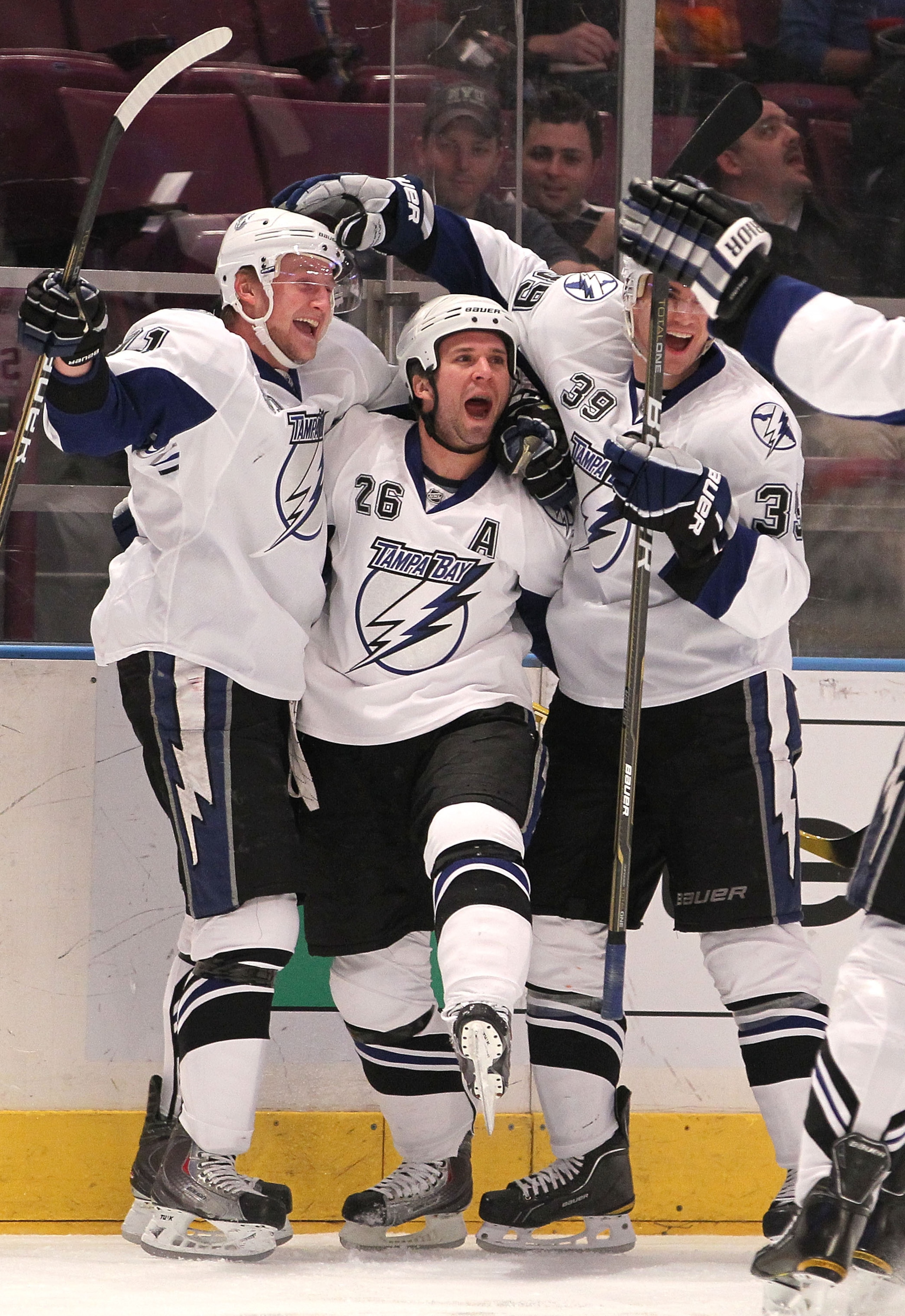 NEW YORK, NY - DECEMBER 23: Steven Stamkos #91, Martin St. Louis #26, and Mike Lundin #39 of the Tampa Bay Lightning celebrate a goal by St. Louis during an NHL hockey game against the New York Rangers at Madison Square Garden on December 23, 2010 in New NEW YORK, NY - DECEMBER 23: Steven Stamkos #91, Martin St. Louis #26, and Mike Lundin #39 of the Tampa Bay Lightning celebrate a goal by St. Louis during an NHL hockey game against the New York Rangers at Madison Square Garden on December 23, 2010 in New
