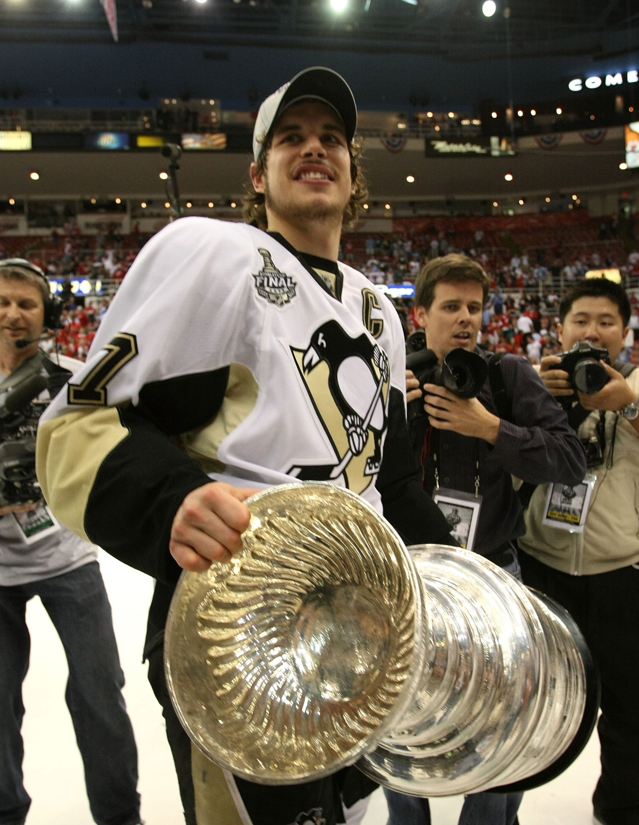 DETROIT - JUNE 12:  Sidney Crosby #87 of the Pittsburgh Penguins holds the Stanley Cup following the Penguins victory over the Detroit Red Wings in Game Seven of the 2009 NHL Stanley Cup Finals at Joe Louis Arena on June 12, 2009 in Detroit, Michigan.  (P